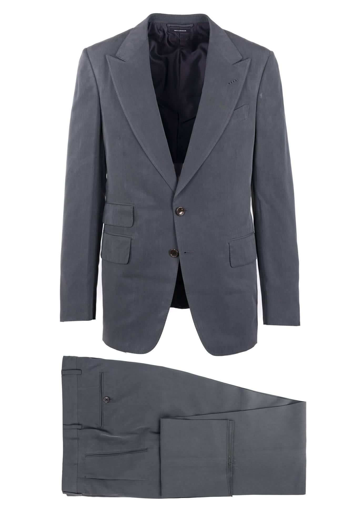 The signature Tom Ford Shelton suit updated in a 100% silk textile with a slate gray color tone. This constructed Shelton base jacket is finished with notch lapels with flap pockets in a two button silhouette. The Suit has a soft and smooth finish