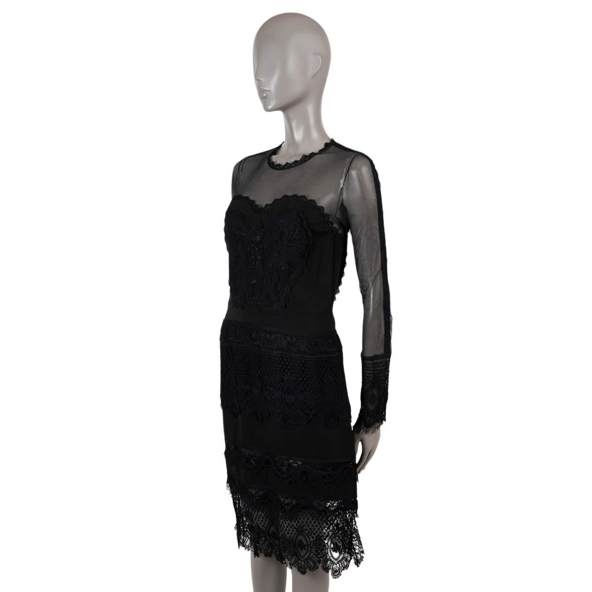 100% authenticTom Ford embroidered lace dress in black cotton (100%). Feattures a round lace-trimmed neck, long tulle sleeves in silk (100%) with embroidered cuffs. Opens with a silver zipper in the back and button. Unlined. Has been worn and is in