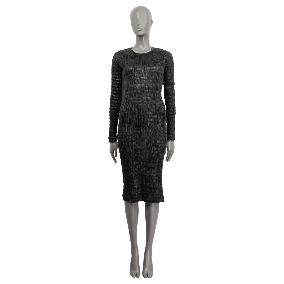 100% authentic Tom Ford smocked long sleeve mid-calf dress in black lamb leather (100%). Opens with an anthracite metallic zipper on the back. Lined in silk (94%) and elastane (6%). Has been tried out once and is in virtually new