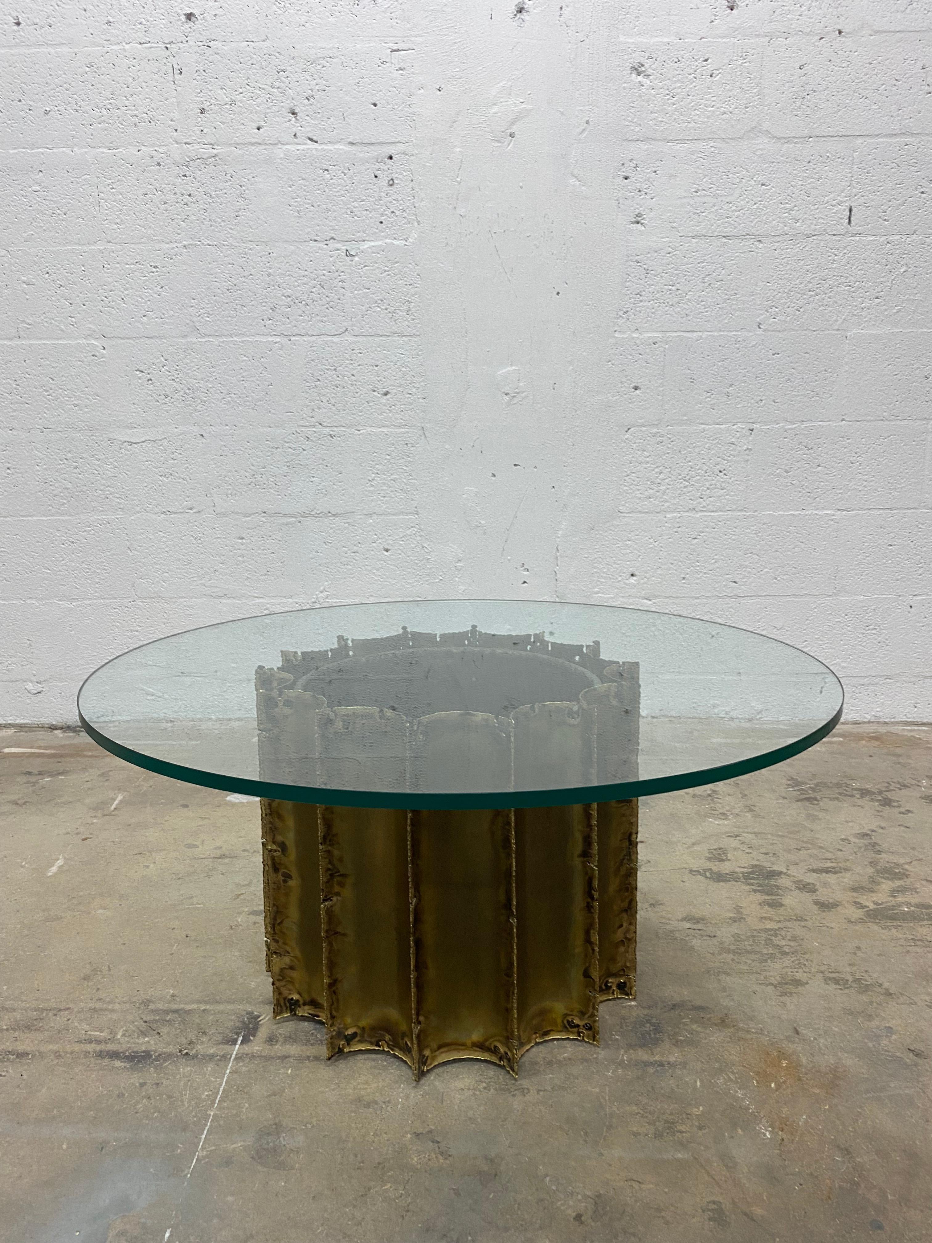 Torch cut brass brutalist base with smoked glass top coffee table by Tom Greene, 1970s.