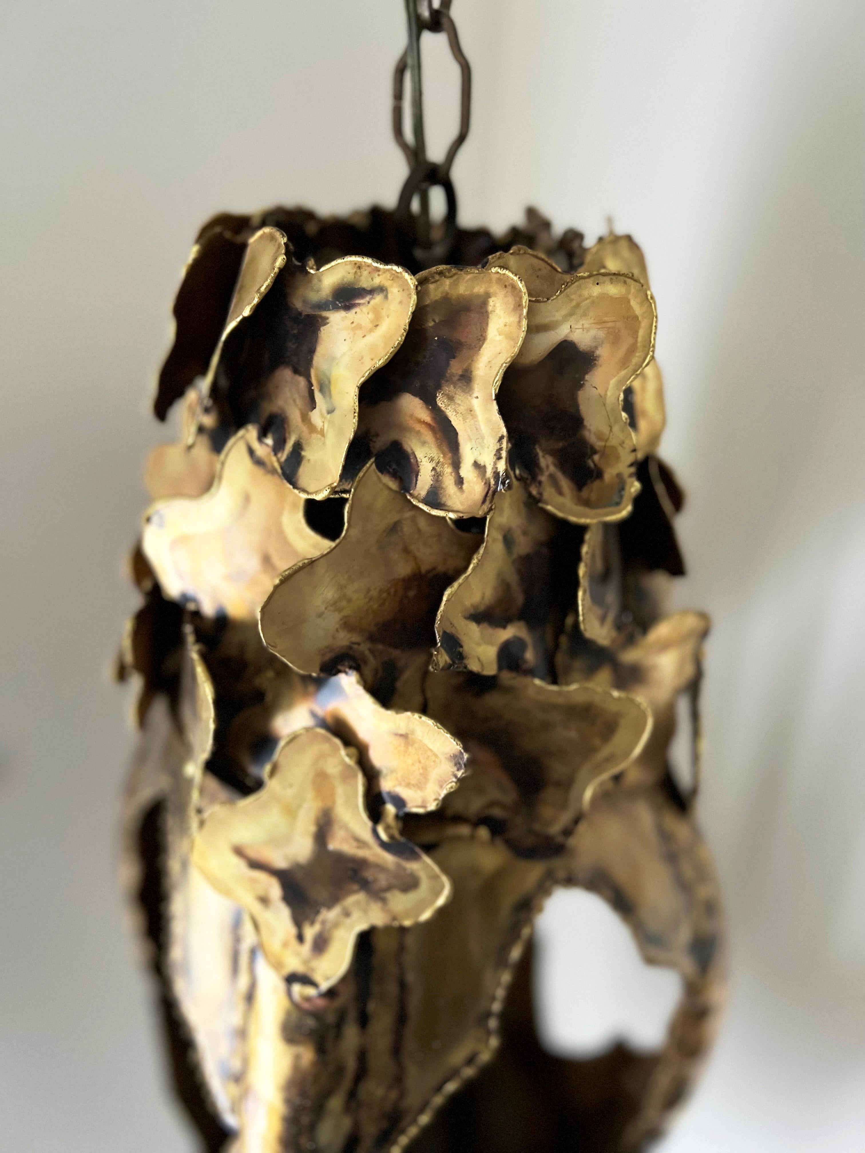 Striking, large Brutalist Mid Century pendant chandelier designed by Tom Greene for Feldman Lighting Co. in the 1960s. Beautiful craftsmanship with a lovely patinated brass, this chandelier is a head turner and substantial in both size and presence.