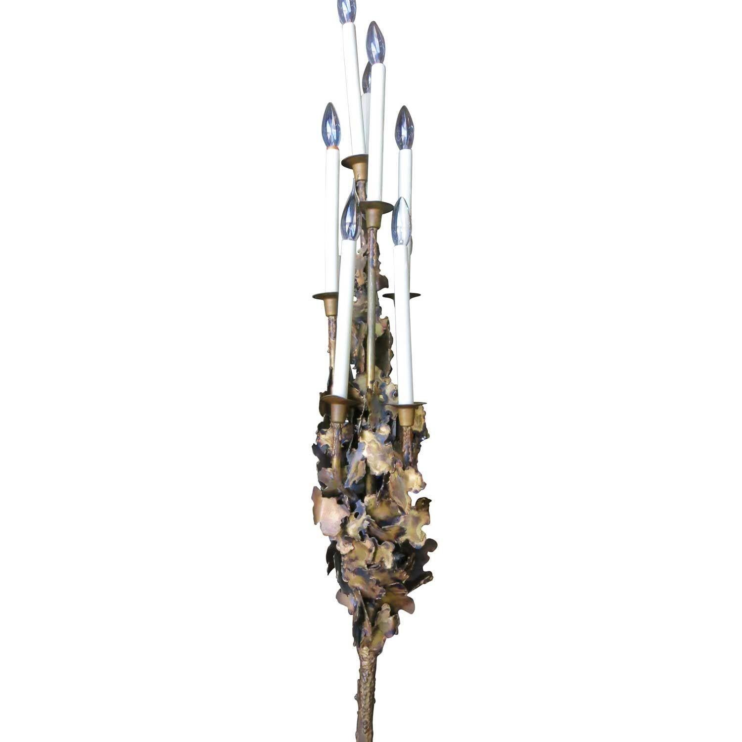 This Tom Greene style Brutalist brass Torchère features a series of multilevel of candles and sculpted torch-cut accents, circa 1970.