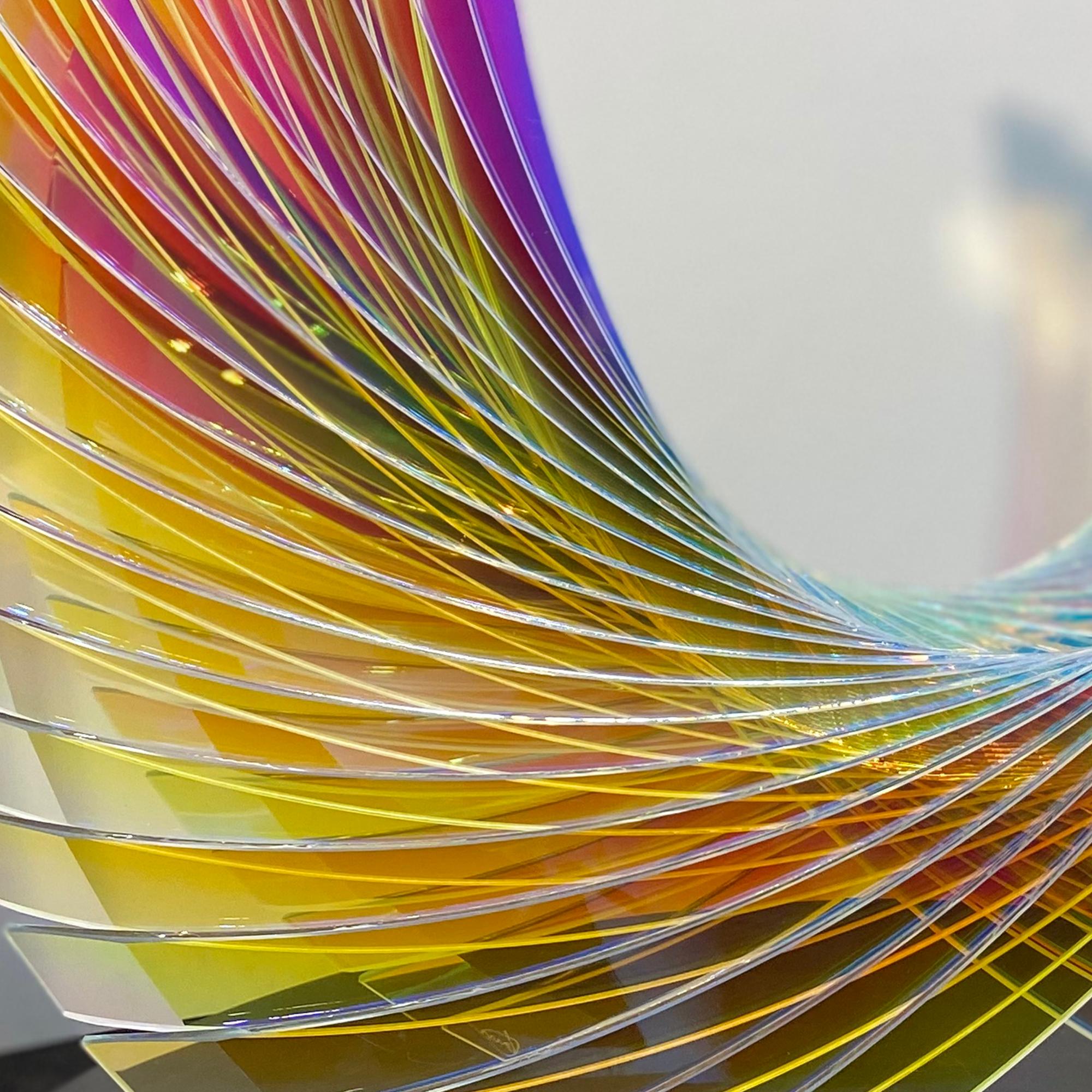 Starfire Sunburst Dichroic Wings’ is an abstracted glass sculpture featuring brilliant multi color dichroic glass. The sculpture strikes beautiful simplicity with its intertwining lines, along with its inspired depiction of wings. The subtle use of