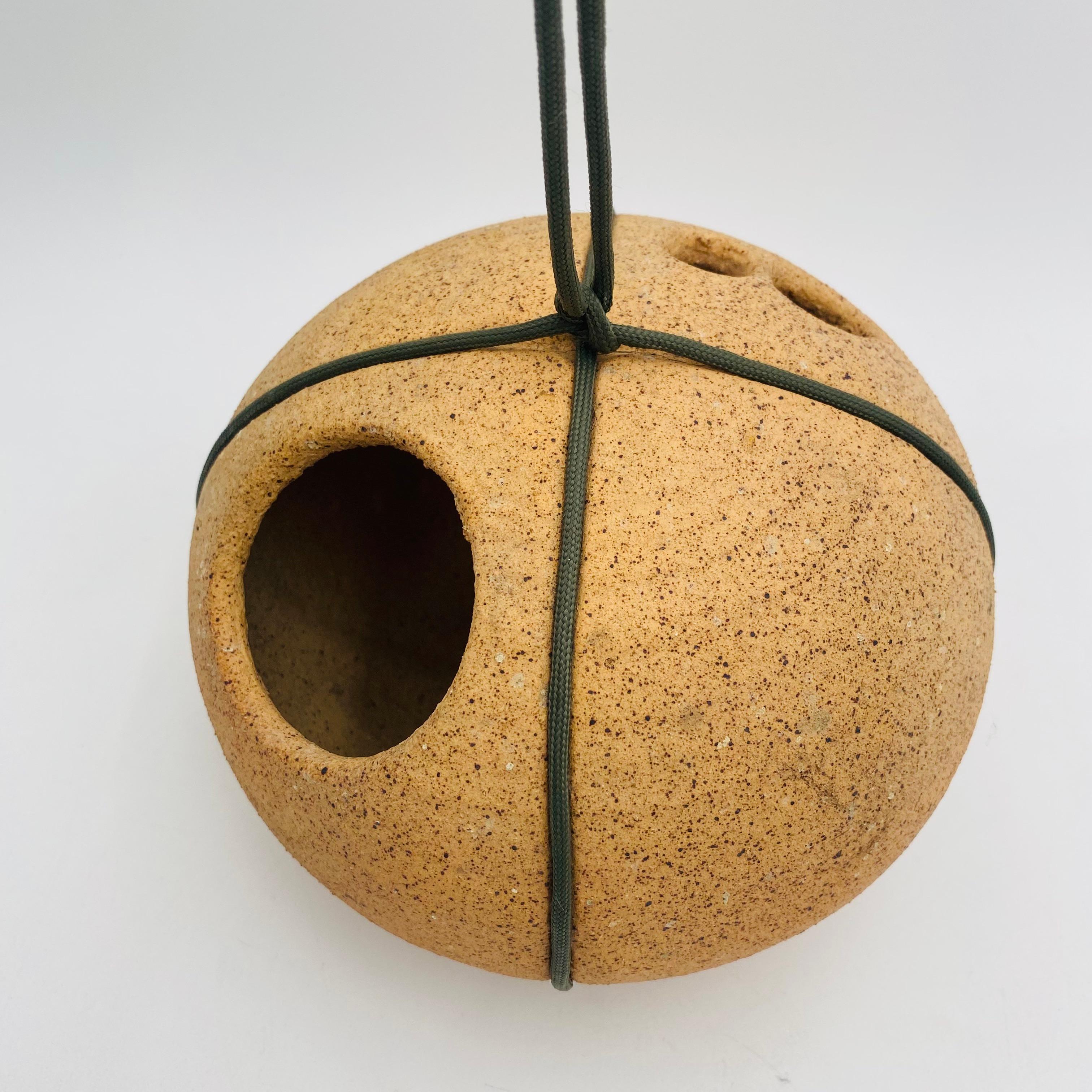 Rare stoneware birdhouse by California artist Tom McMillin. Stunning organic unglazed round form. The form has recessed lines for a rope to wrap around and hang the birdhouse. This piece is a wonderful example of California studio pottery from the