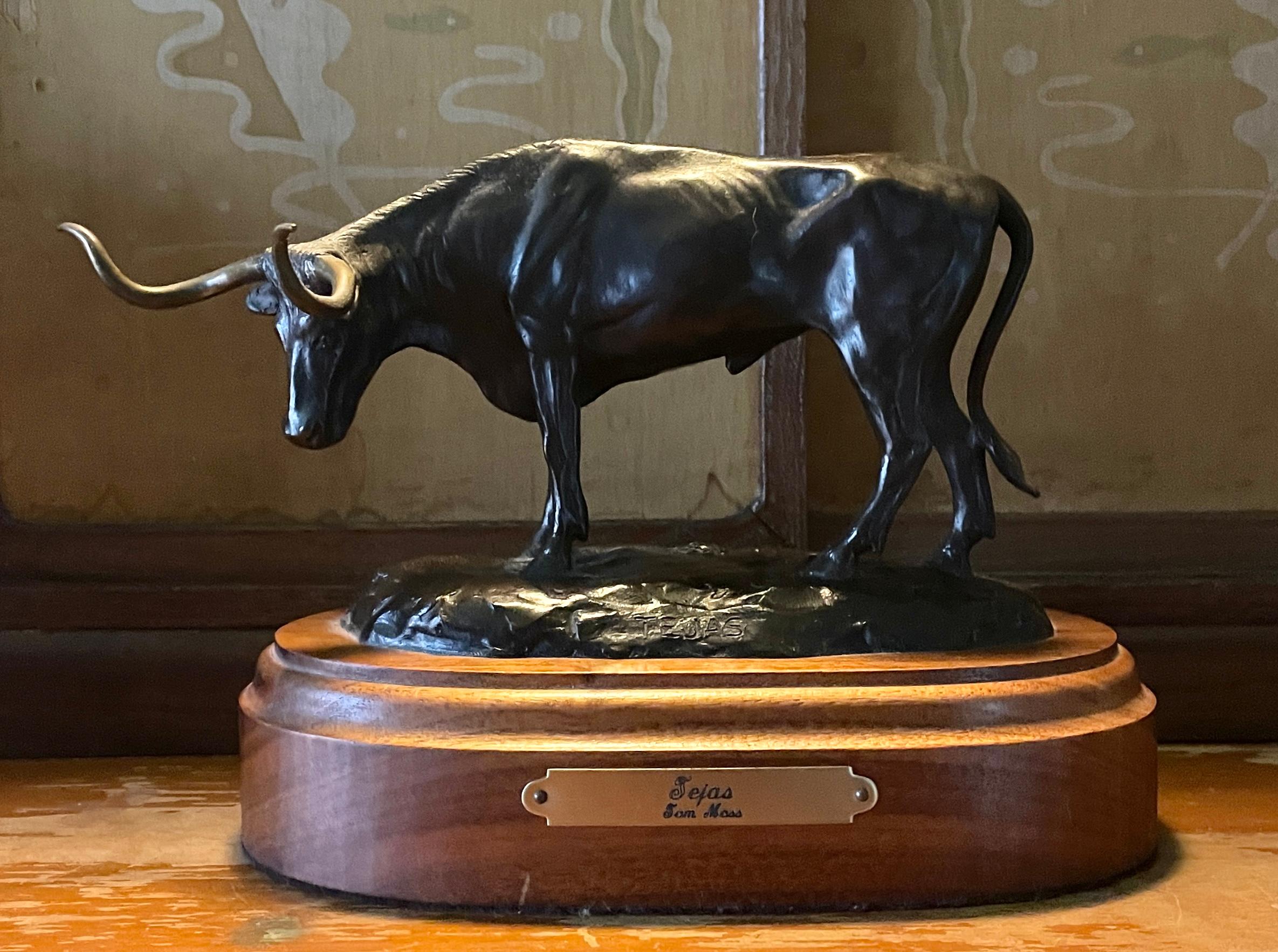 Tom Moss (American, b. 1936) 
'TEJAS' Bronze Steer Bull on wooden base
W 9 x D 4.5 x H 6 in
Total Wt. 4 lbs. 11 oz.
Inscribed in front of bronze; TEJAS
Inscribed in rear of bronze; Tom Moss © 20/50