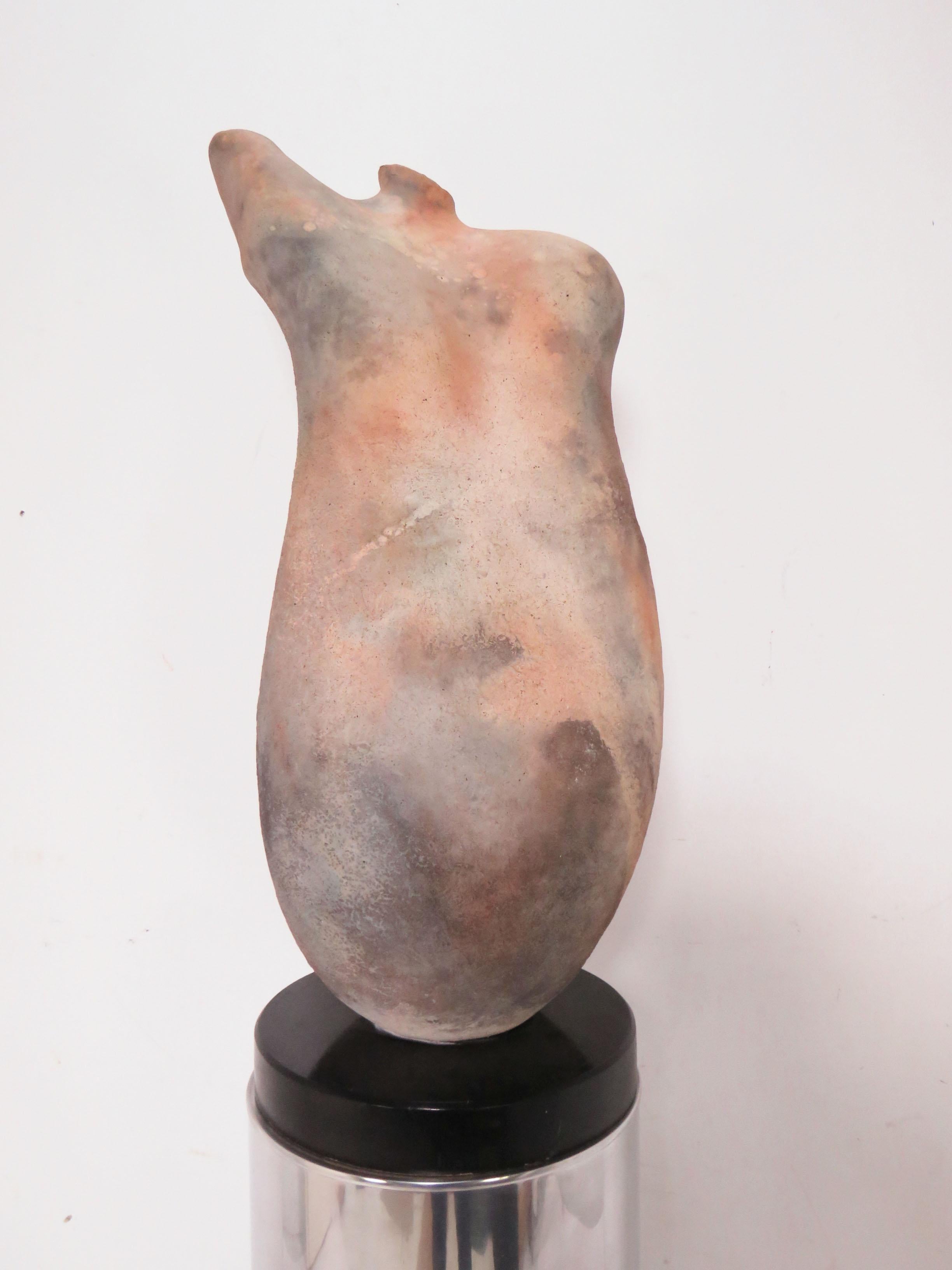 Raku abstract torso sculpture by master potter Tom Neugebauer, dated 1988. Sculpture (which is affixed to lacquered black base) measures: 28.75