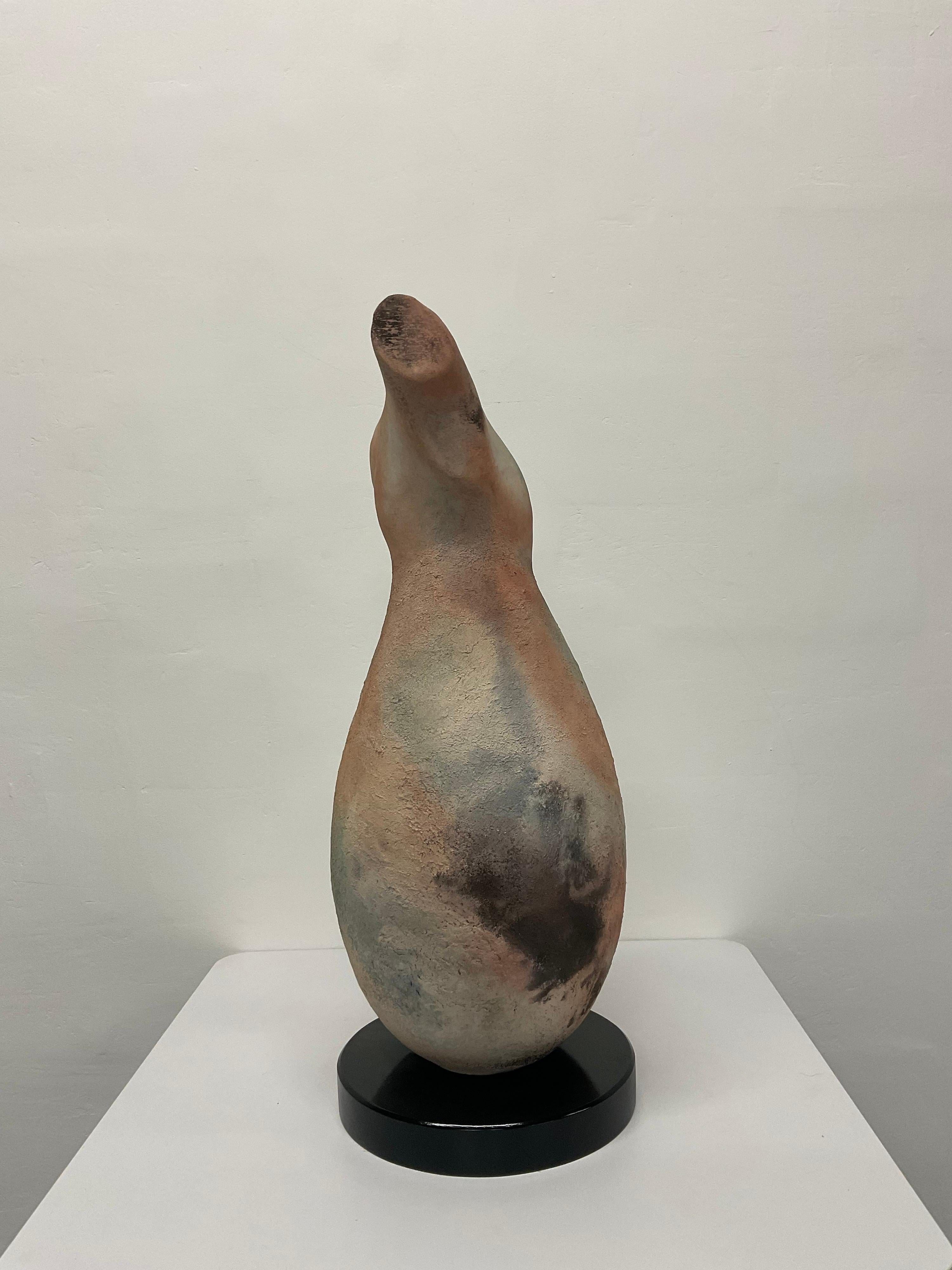 Raku abstract torso sculpture by master potter Tom Neugebauer, dated 1989. Sculpture sits atop black lacquered round wood base. Signed in clay and on underside.