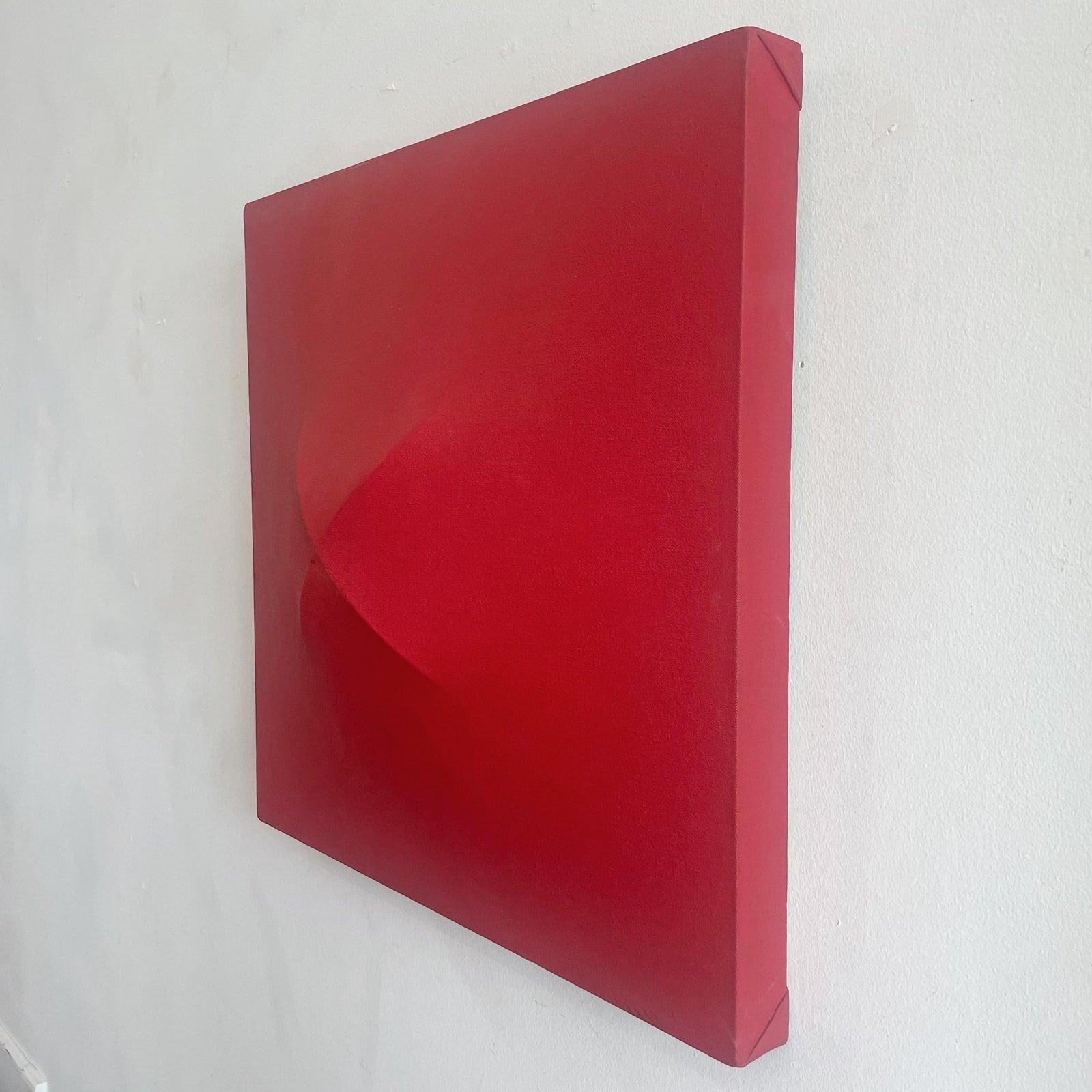 Vintage monochromatic red art by Tom Schmitt on three dimensional shaped canvas. Signed on reverse. circa 1968.