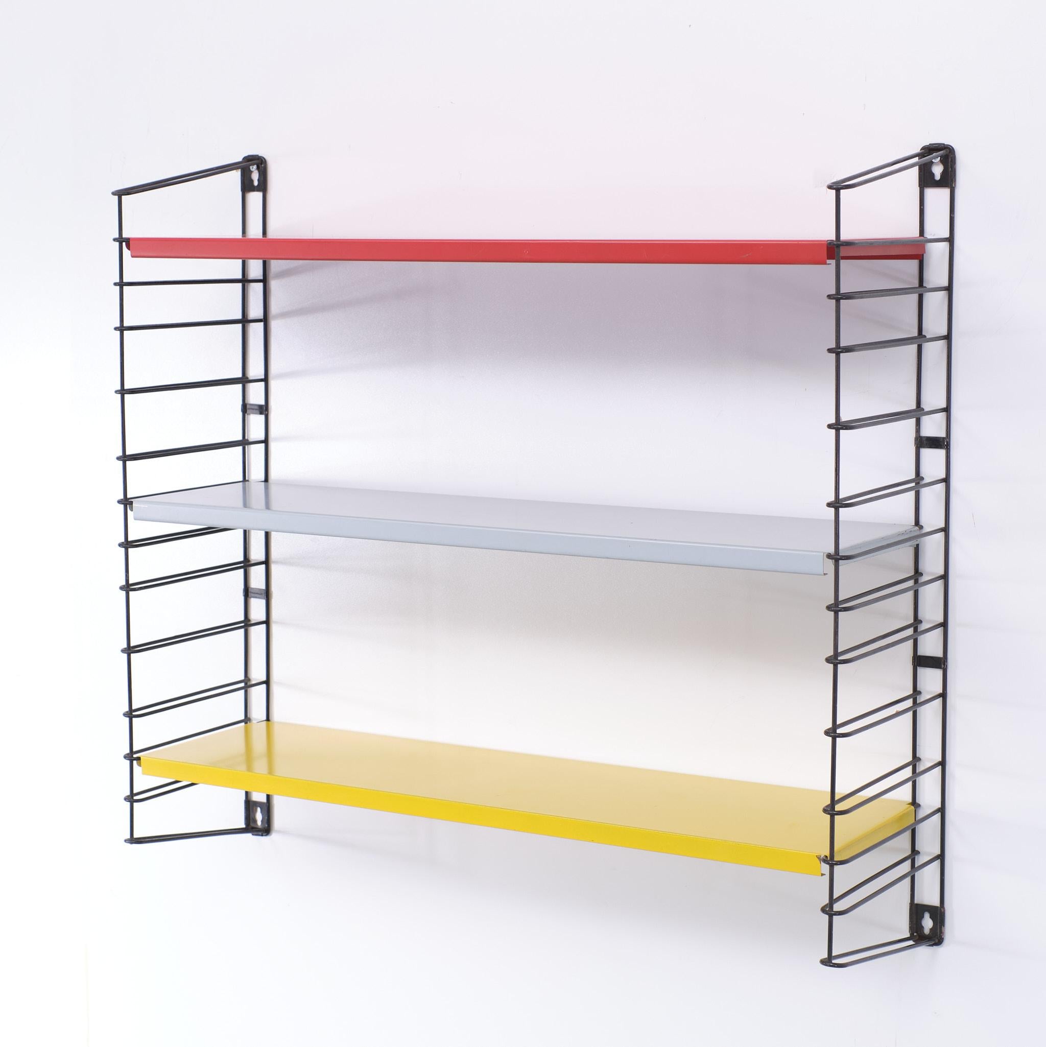 A real design classic this Tomado wall rack, Two ladders with 3 shelves, In the colors red yellow and grey 
very good condition several sets available.
