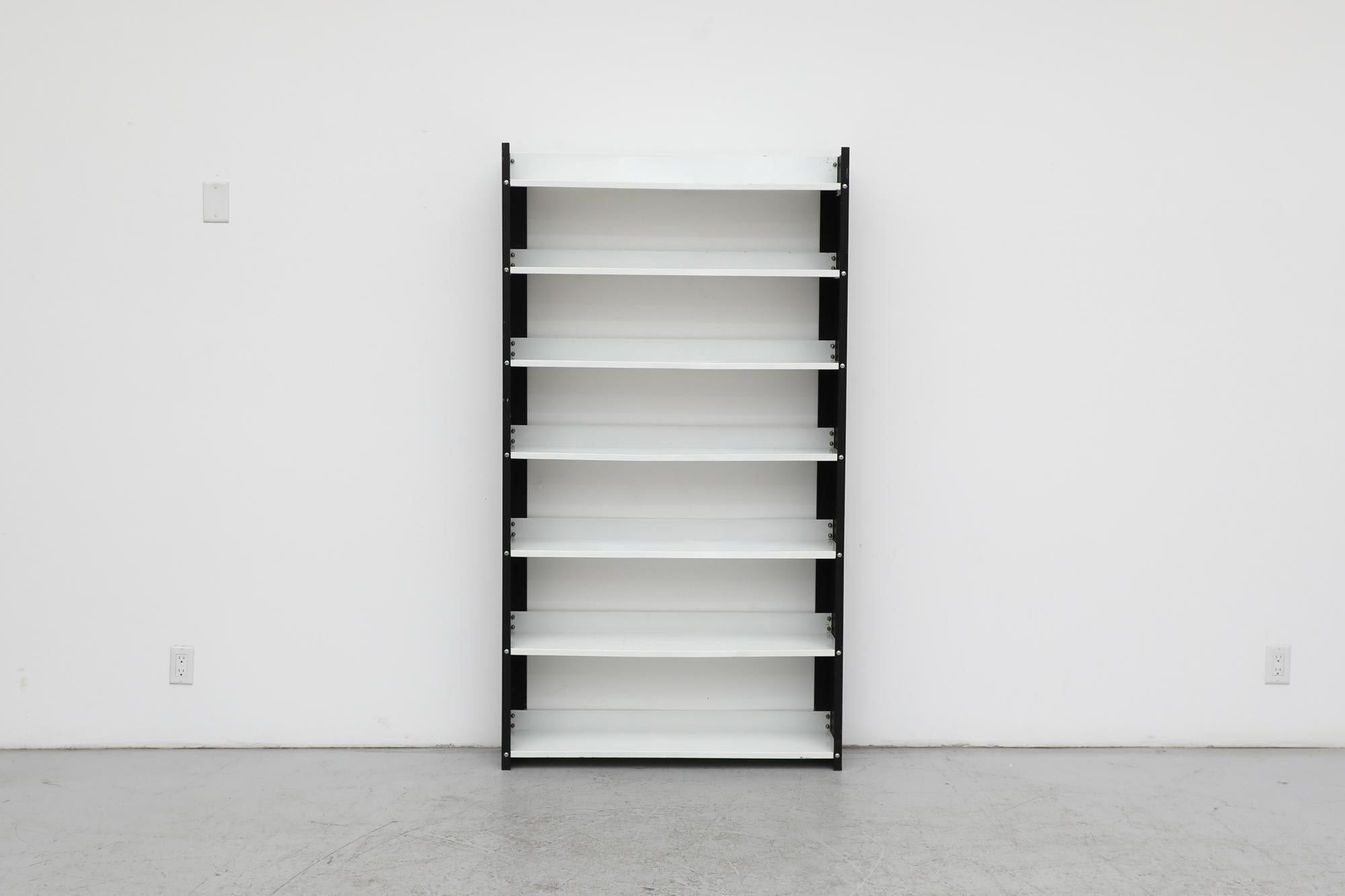 Mid-Century, black and white enameled metal industrial bookshelf by Jan van der Togt for Tomado. Lightweight versatile shelving unit perfect for displaying your favorite books and accessories. In original condition with some visible wear and