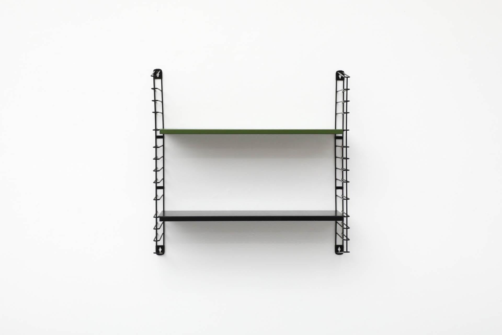 Single section, two shelf, Dutch Mid-Century, wall mounted shelving unit with green and black enameled metal shelves on black enameled metal wire risers. Manufactured by Tomado in the 1960's. In original condition with visible wear consistent with