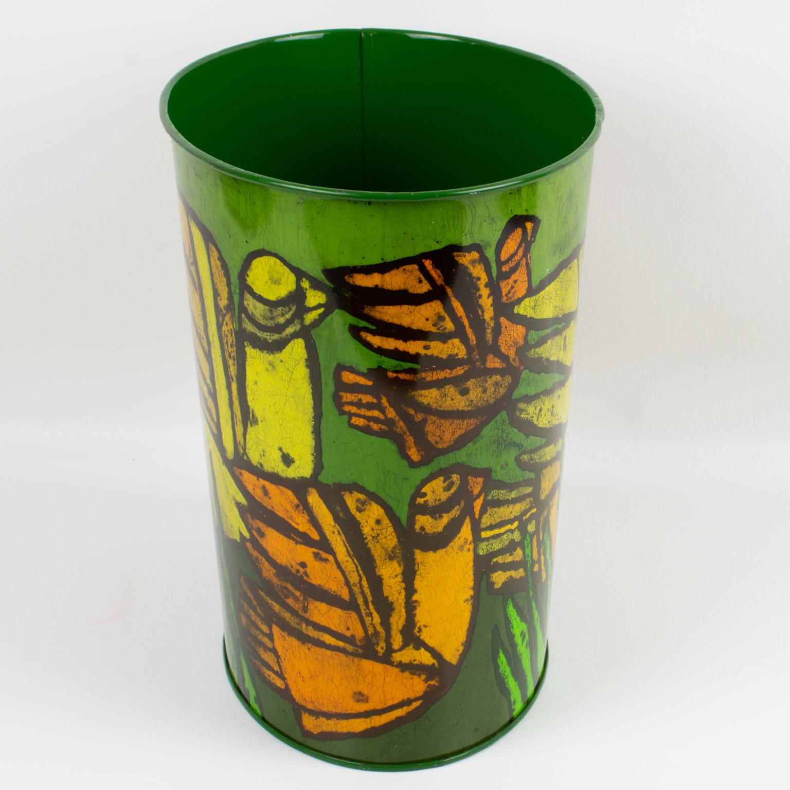A functional 1960s Mid-Century-Modern desk accessory, office waste-basket designed by Tomado, Holland. Ovoid shape in a bright green metal and polychrome typical modernist design of exotic birds in yellow, black, and orange colors. Marking of