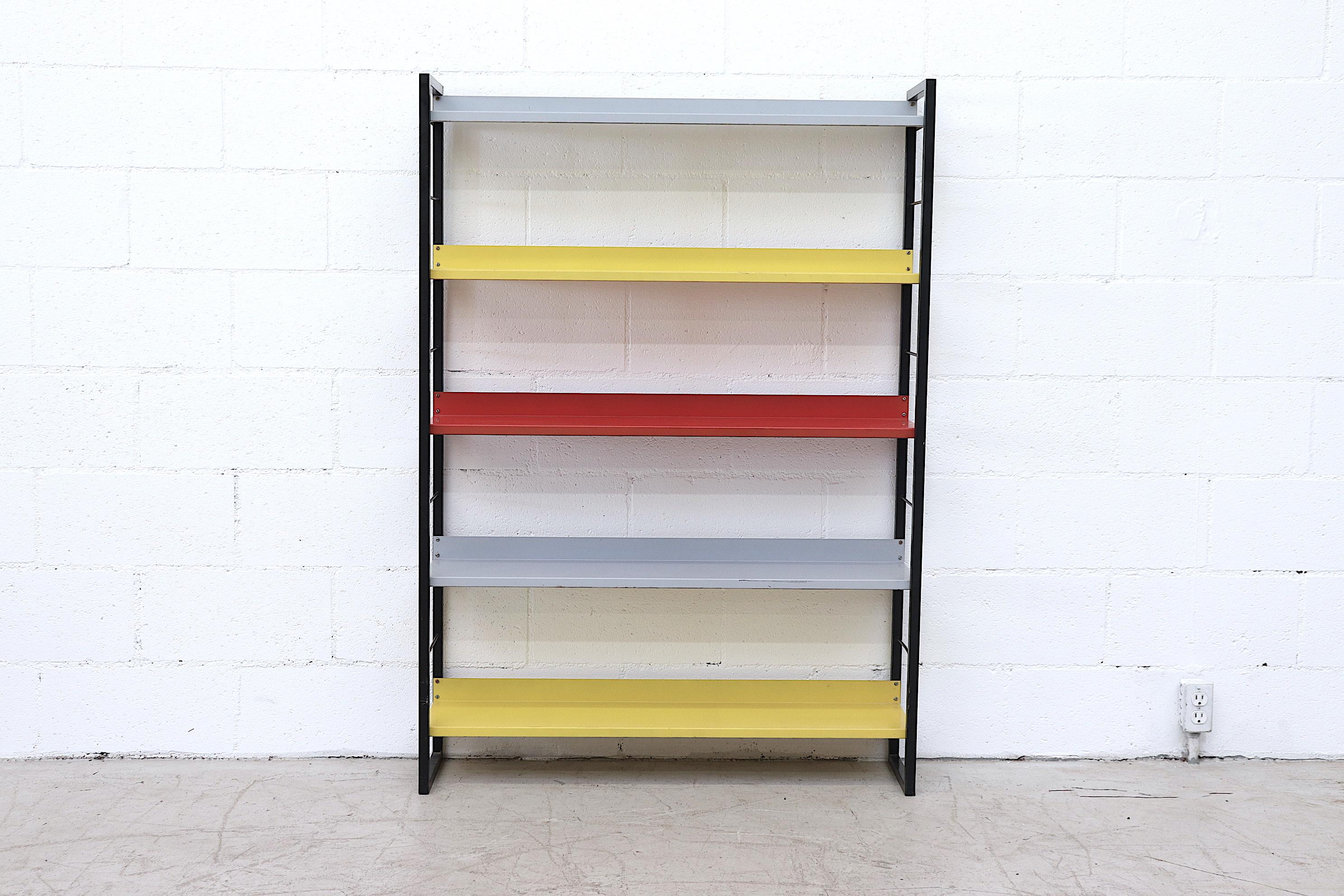 From famed Dutch manufacturer Tomado (An acronym for Van der TOgt Massa Artikelen DOrdrecht meaning Van Der Togt Mass Articles Dordrecht - Dordrecht being the city the company originated from ) comes this enameled metal standing book shelf with