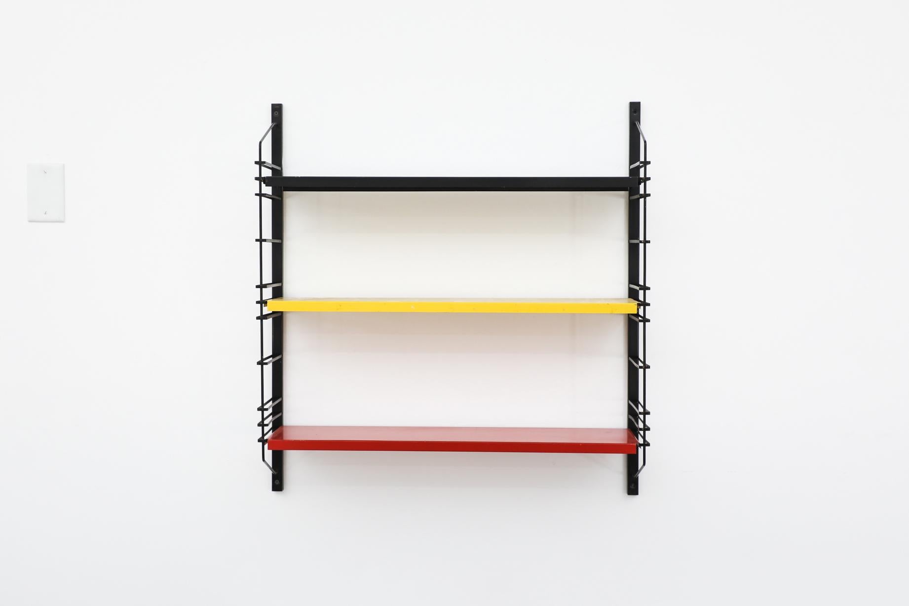 Mid-Century Drentea Emmen industrial shelving with black, yellow and red shelves on black enameled metal wire risers. The shelves rest on the wire risers and can be arranged to different positions. In original condition with visible wear and
