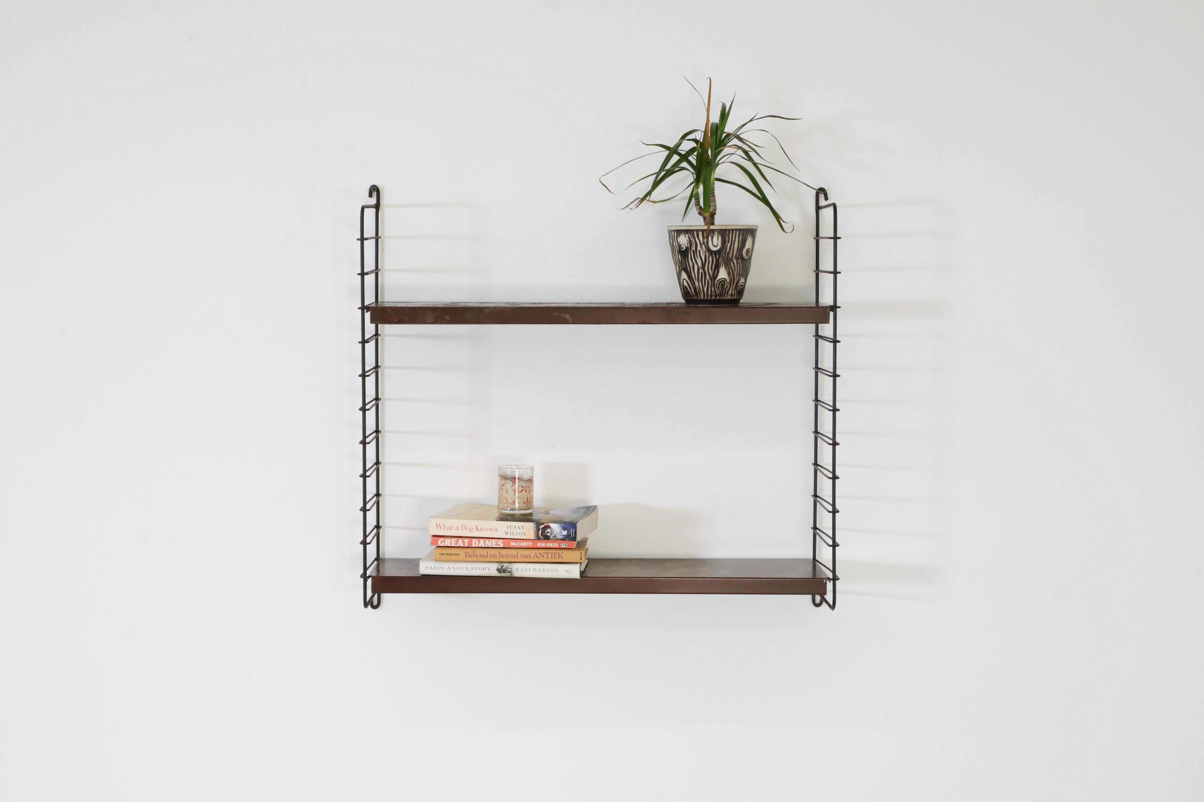 Dutch Mid-Century, single section, Tomado style, industrial wall mount shelving unit with handsome brown enameled metal shelves on black enameled wire risers. A lovely piece in very original condition with heavy visible wear including some enamel