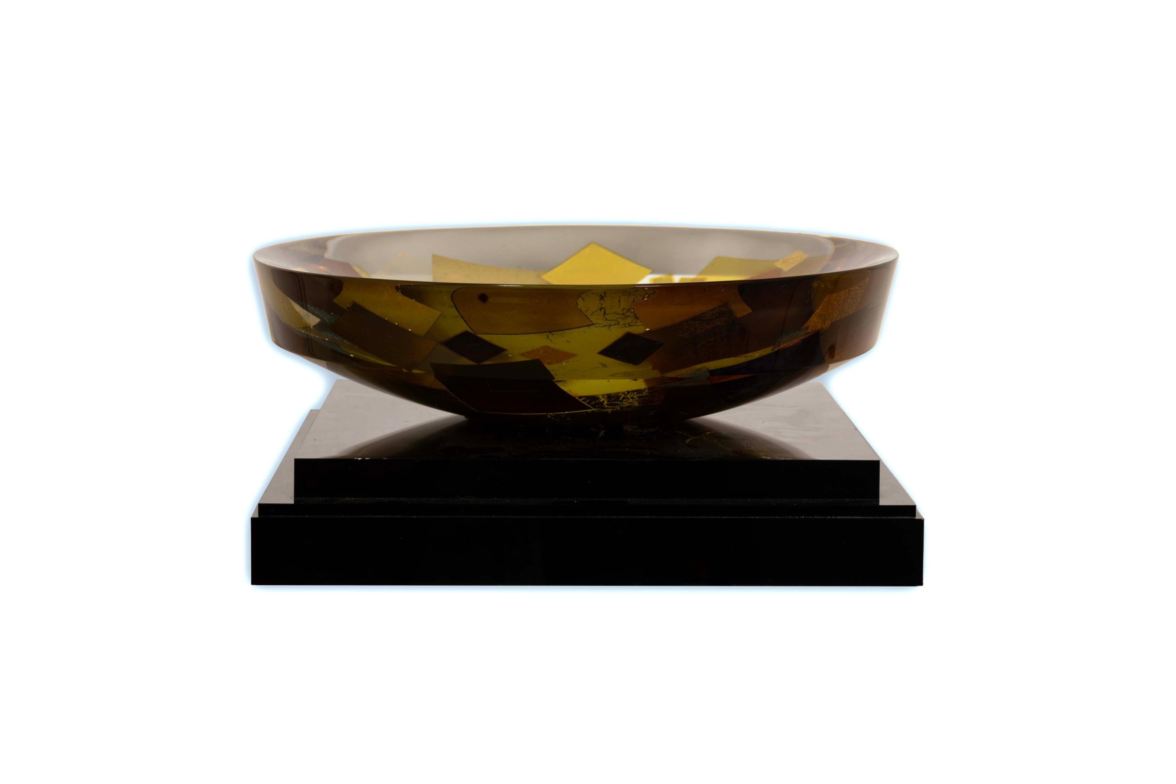 A visually stunning art glass bowl on a black base titled 
