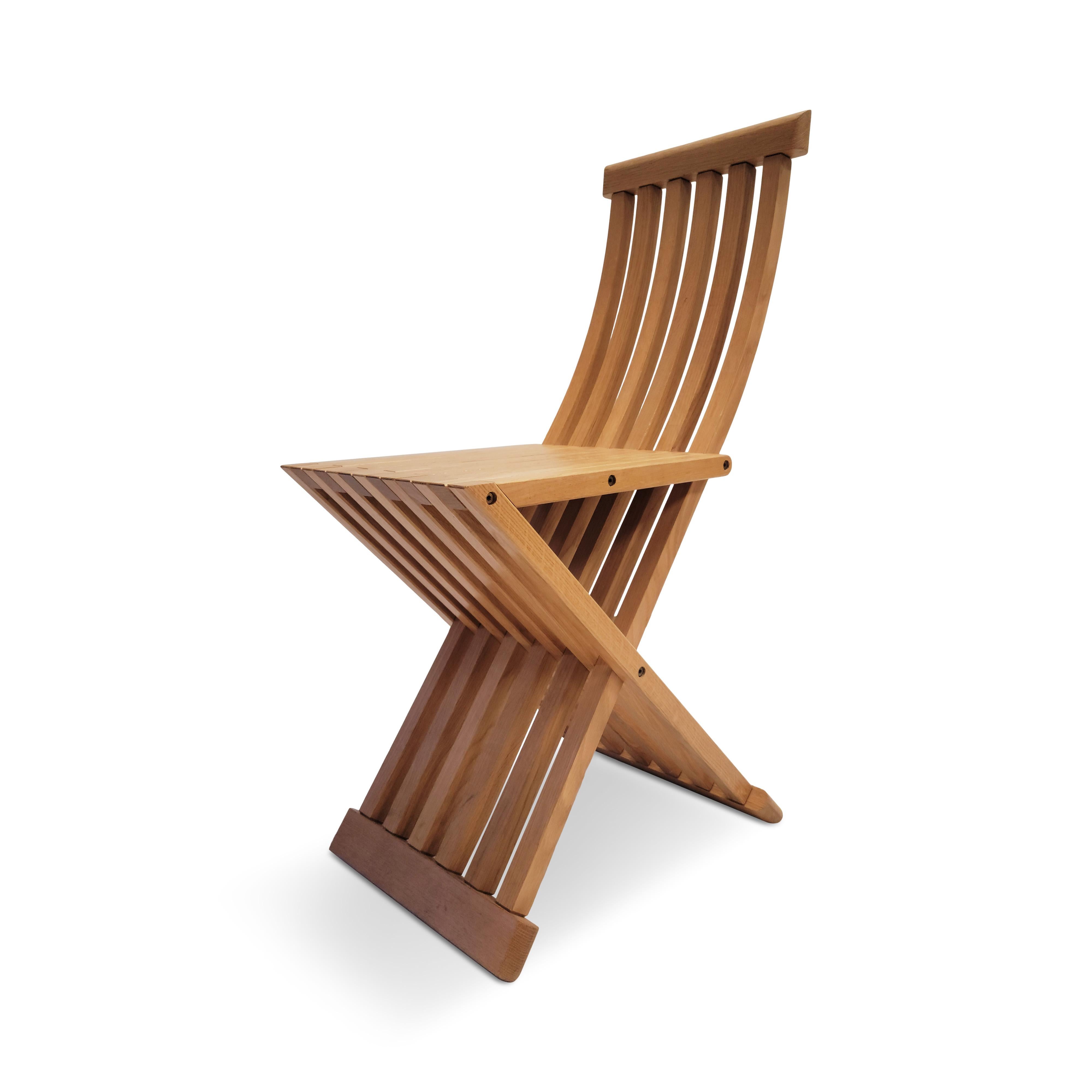 Considered an homage to Paolo Uccello, a 15th century painter and mathematician, and manufactured by Simon Gavina in Italy, the Tomasa chair is a simple and beautiful design. Constructed of wax finished curved oak slats forming the back and seat, as