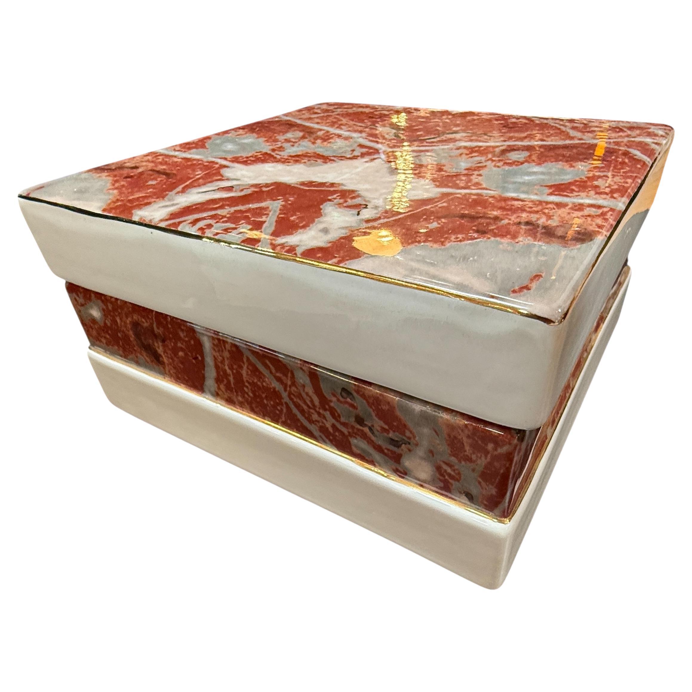 Caja con tapa de cerámica Tommaso Barbi con esmalte marmolizado rojo y detalles dorados en venta