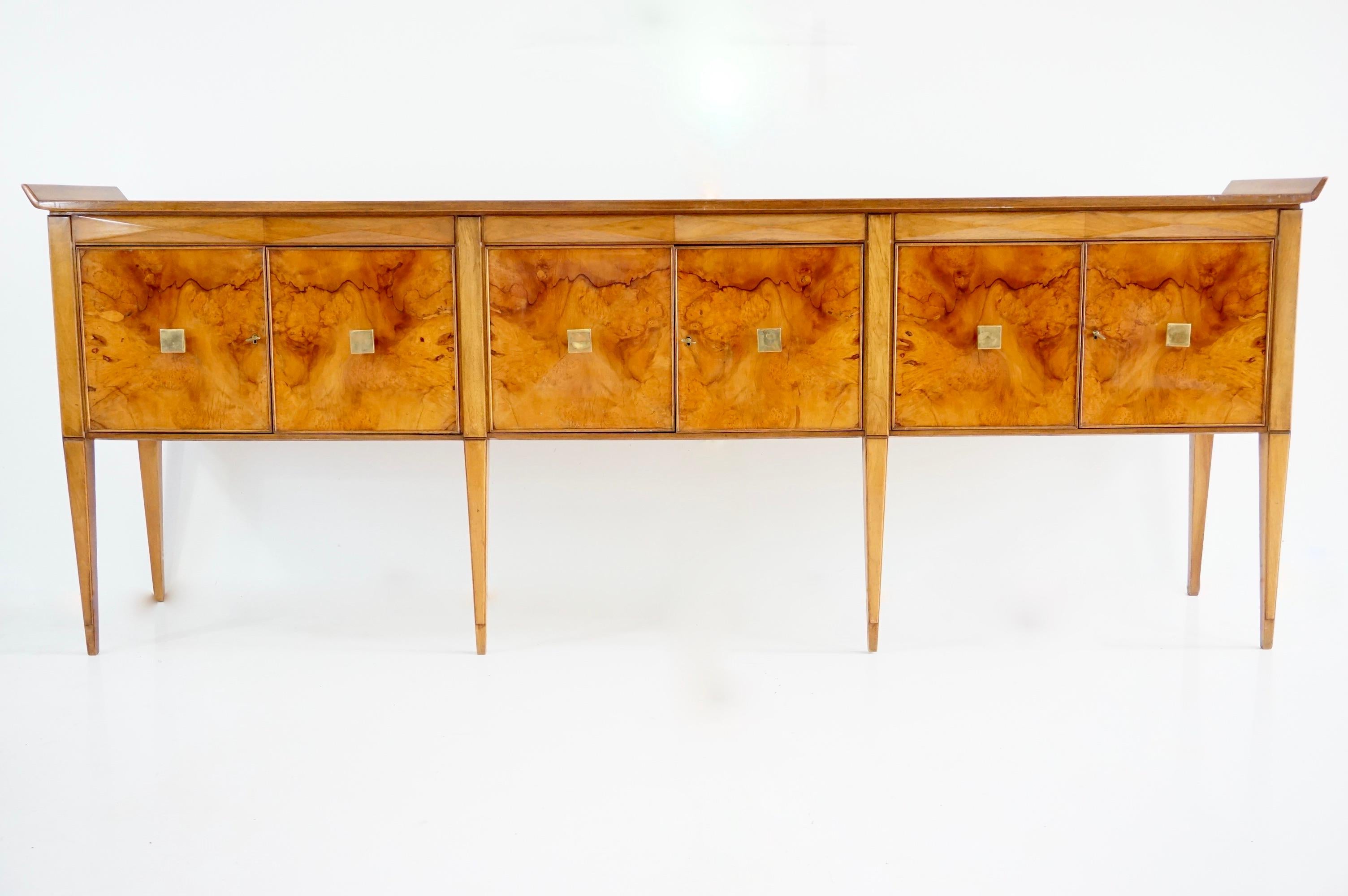 large  and unique sideboard   designed by Tomaso Buzzi and Emilio Lancia circa 1940 
six doors  with a key 

elegant and unique piece in set with a bookcase cabinet
walnut, briar root veneered, brass
the sideboard comes from a private house in