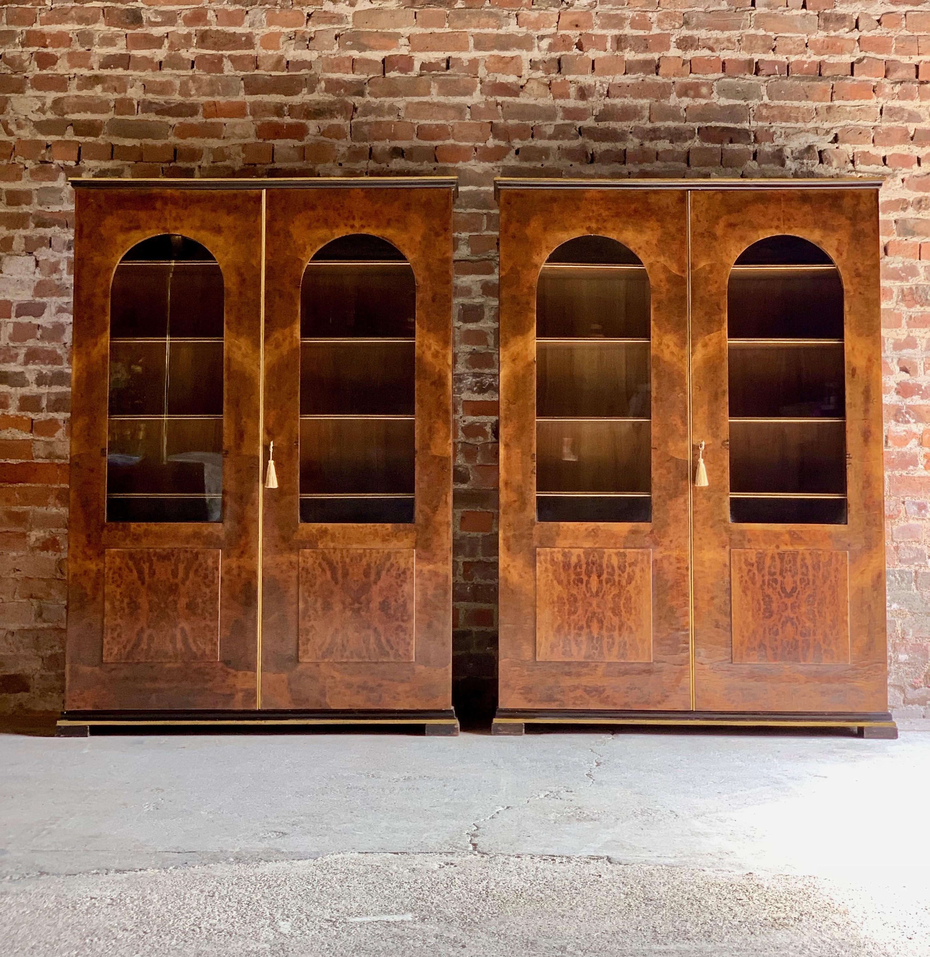 Tomaso Buzzi pair of burr walnut display cabinets bookcases, Italy, circa 1929.

Tomaso Buzzi a magnificent pair of rare and important Ferrara burr root walnut cabinets circa 1929, the rectangular top over arched and glazed brass panel doors with