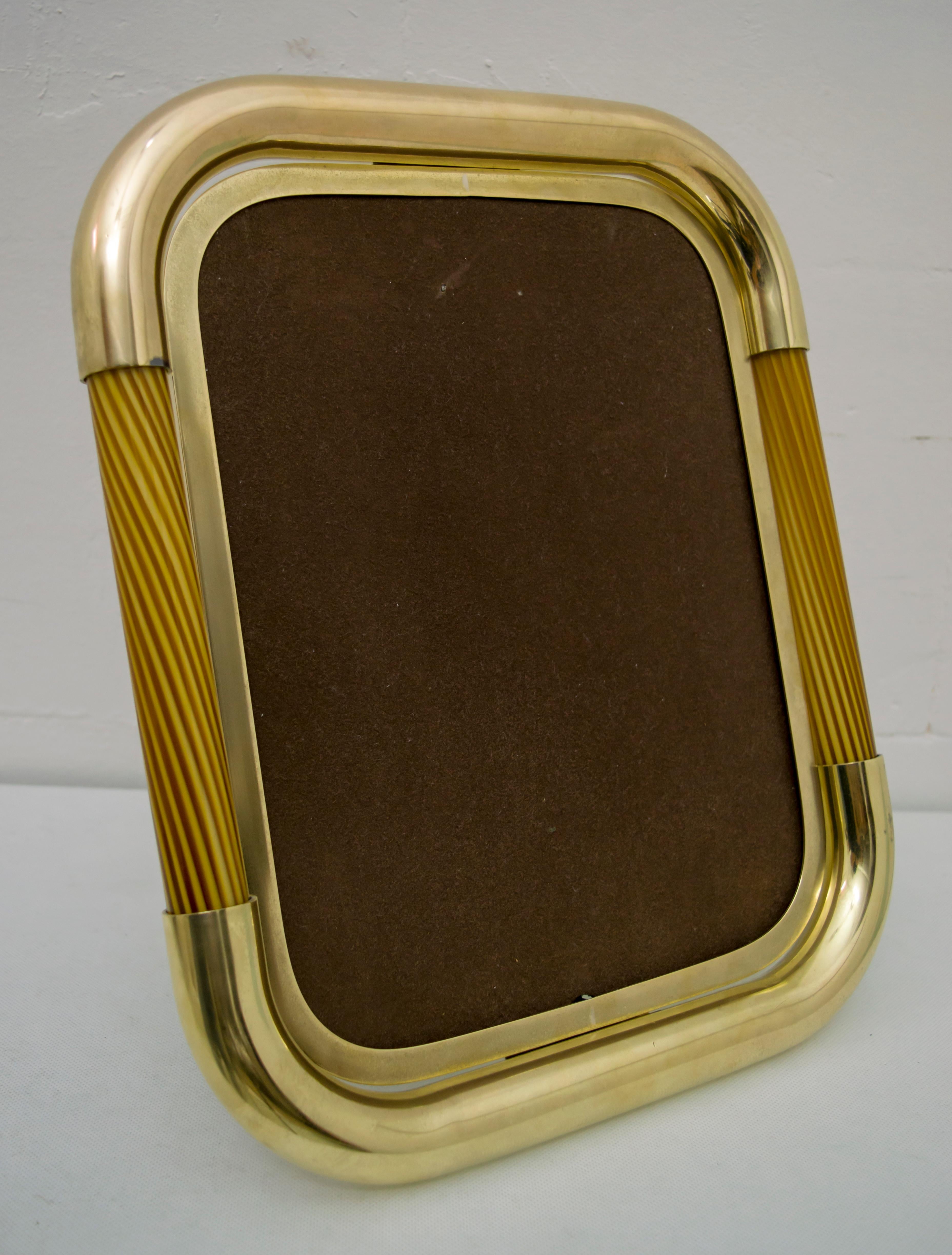 Huge midcentury 1970s frame original iconic designer Tommaso Barbi from Murano manufactured in Italy with a brass plaque inscribed Tomasso Barbi made in Italy.
Remarkable structure in curvilinear brass with beautiful glass rod inserts, mouth-blown