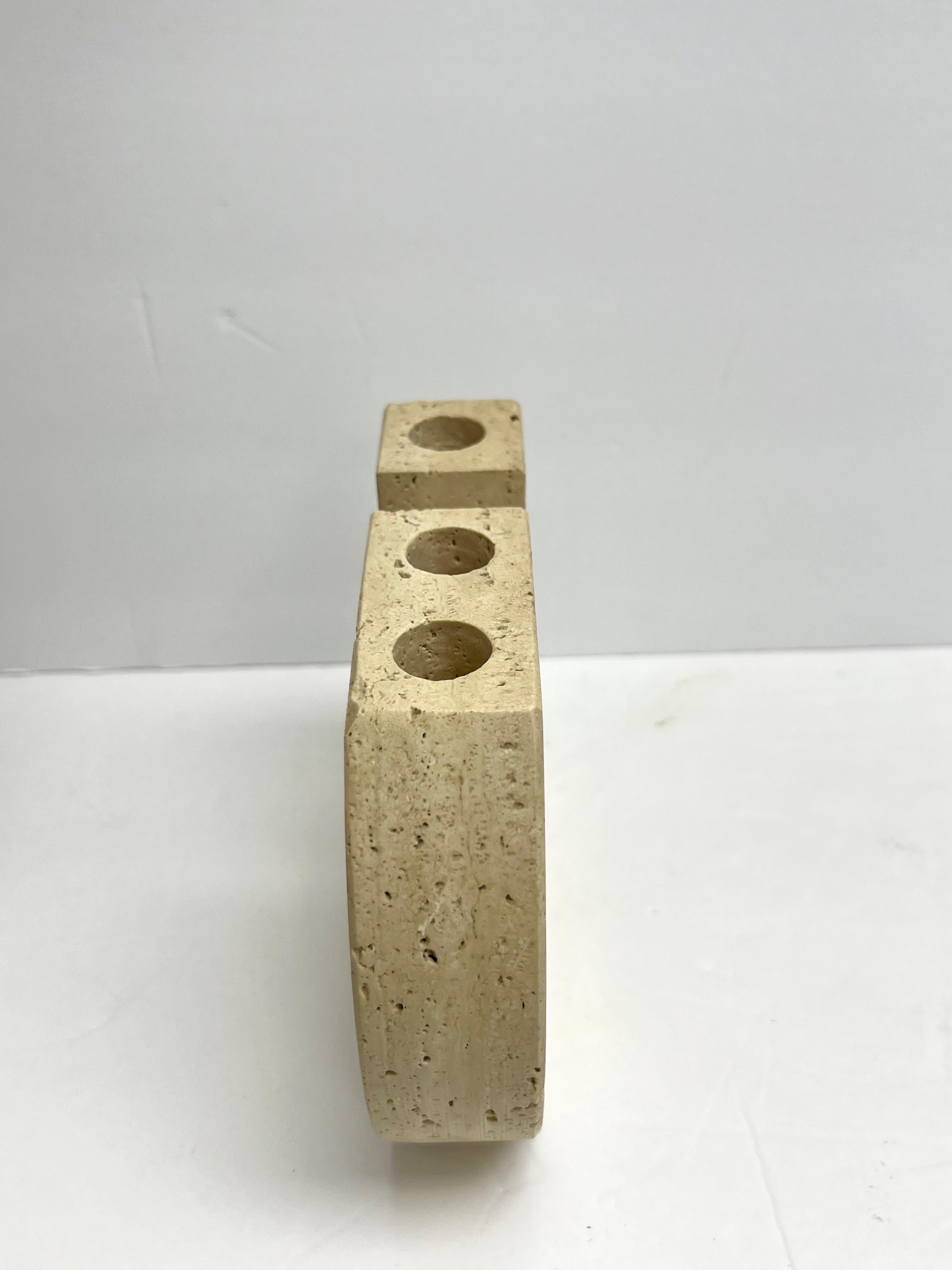 Beautiful candleholder in travertine. Classic shape with the signature “b” design by Tommaso Barbi.