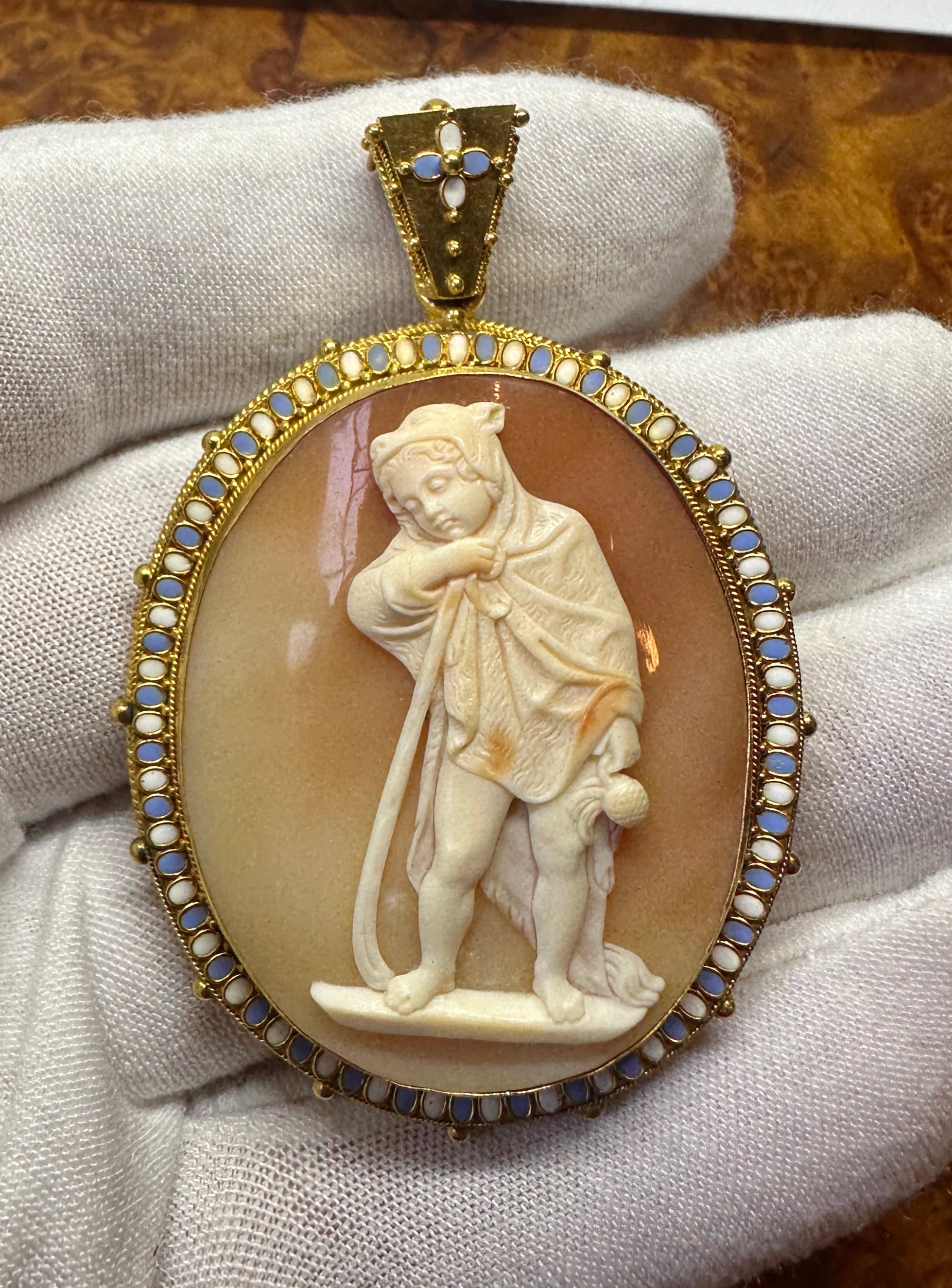 This is one of the most exquisite Antique Victorian - Belle Epoque Cameo Locket Pendant Necklaces by the master cameo carver Tomasso Saulini of Rome, depicting an image of Winter, with a boy dressed in a wolf skin.  The locket is 14 Karat Gold and