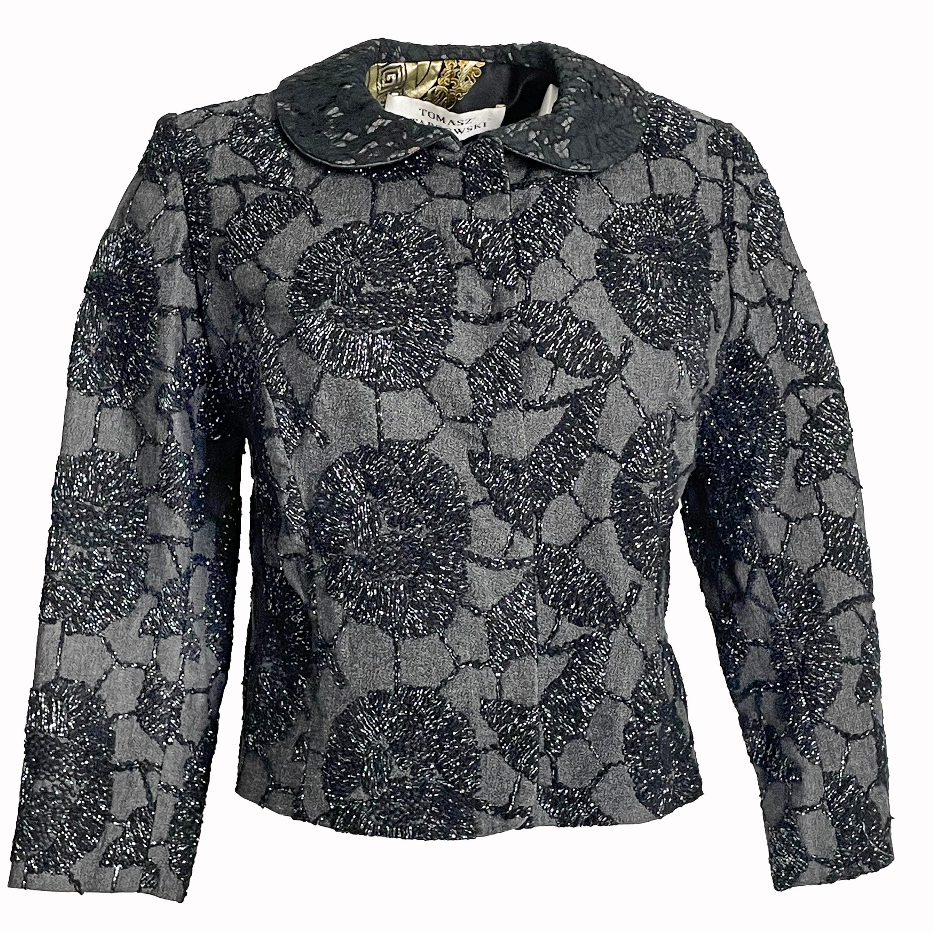 A fabulous and unique cropped jacket by UK designer Tomasz Starzewski, who designed for the late Diana, Princess of Wales amongst other members of the Royal Family, likely made in the 1990s.

The jacket exterior features intricate metallic-thread