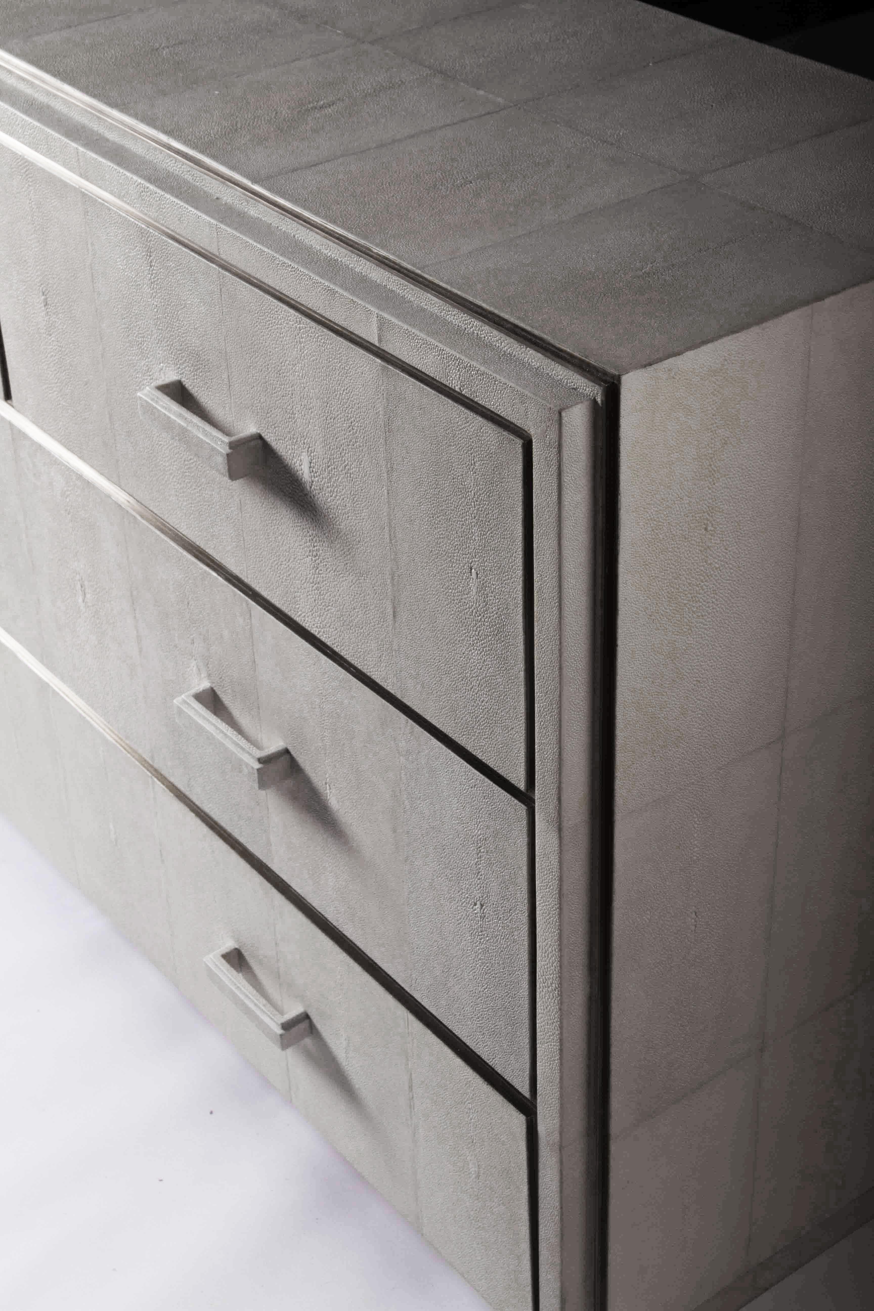 The Tomboy chest of drawers in cream shagreen is a classic piece that would suit any living style. The simplicity of the piece allows for the rich shagreen inlay to speak for itself. The inseams are inlaid with bronze-patina brass strips to add