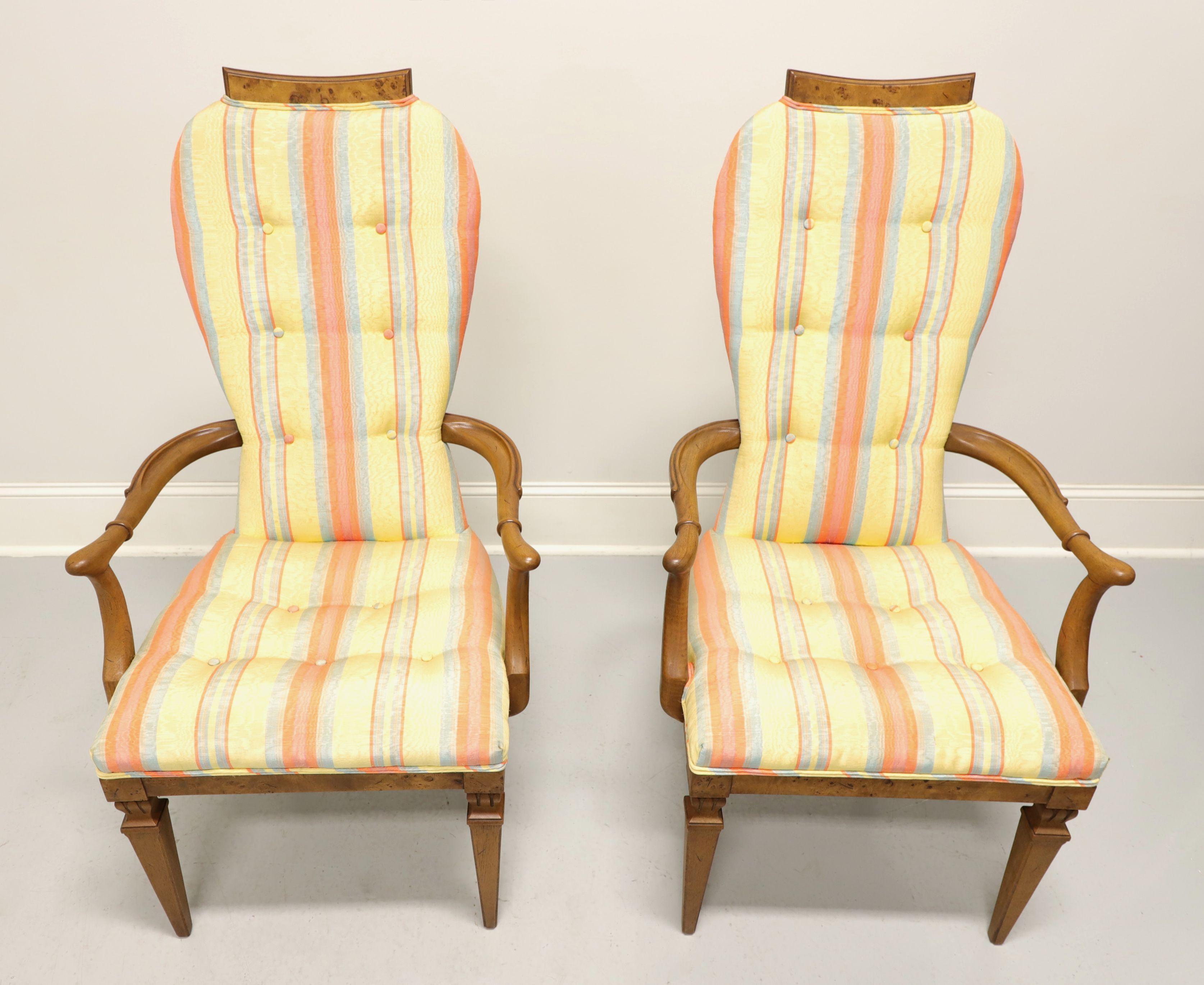 A pair of Mid 20th Century Neoclassical style upholstered dining armchairs by Tomlinson Furniture. Walnut with their Tokay finish, slight distressing, inlaid burl wood to crest rail & apron, curved carved arms, button tufted striped fabric