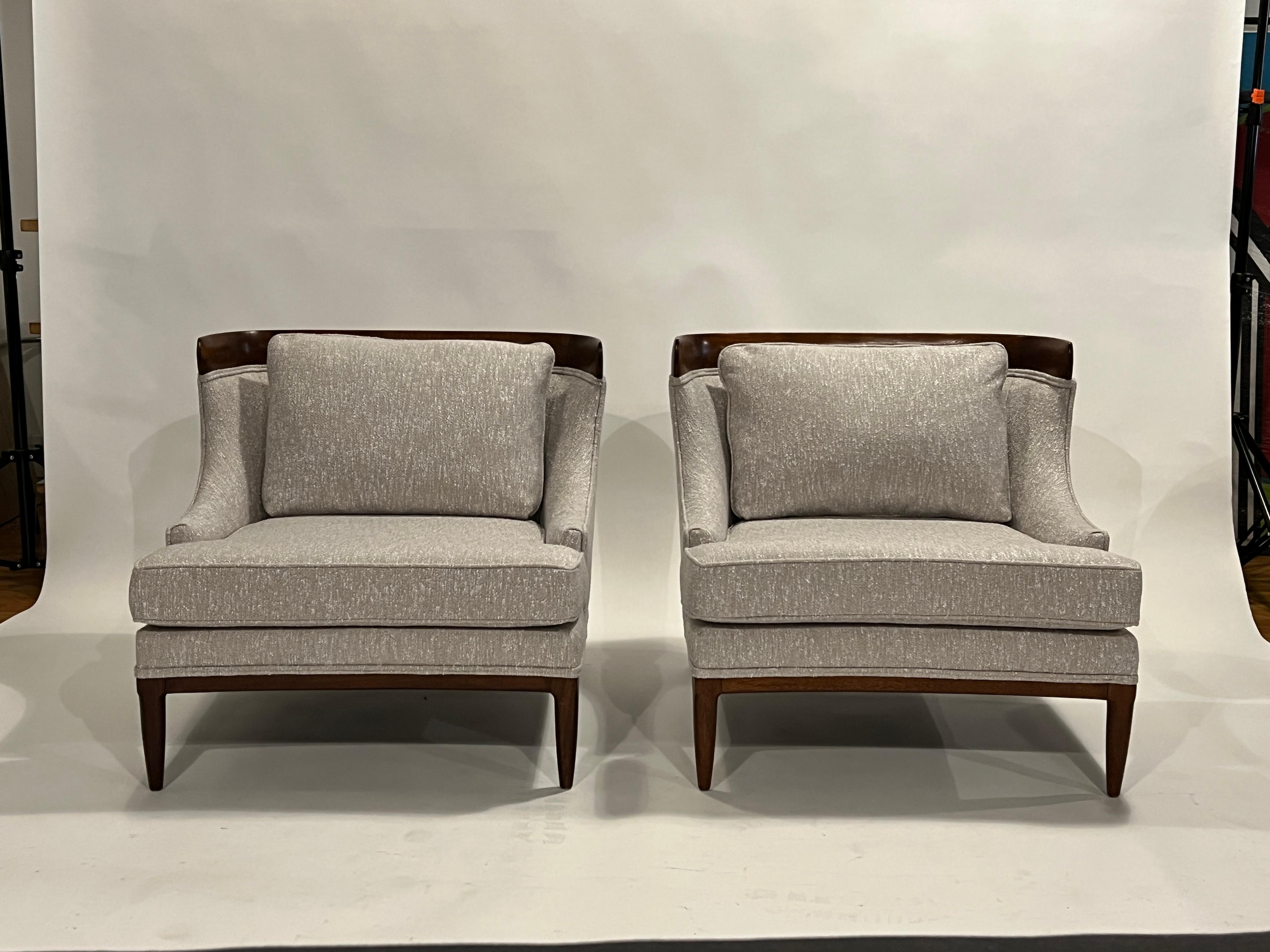 Iconic pair of Hollywood Regency lounge chairs by Erwin Lambeth from the Sophisticate Collection for Tomlinson, 1950's. 
These vintage chairs have been completely restored in the original walnut stain wood and upholstered in a beige and white