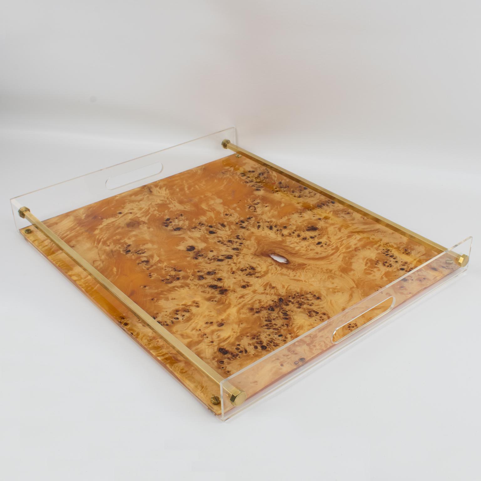 This 1970s Tommaso Barbi barware tray is a stunning piece of Italian design. It features a rectangular large butler shape with a gilt brass gallery and crystal clear Lucite, with a genuine burl wood veneer sheet embedded in the Lucite. The original