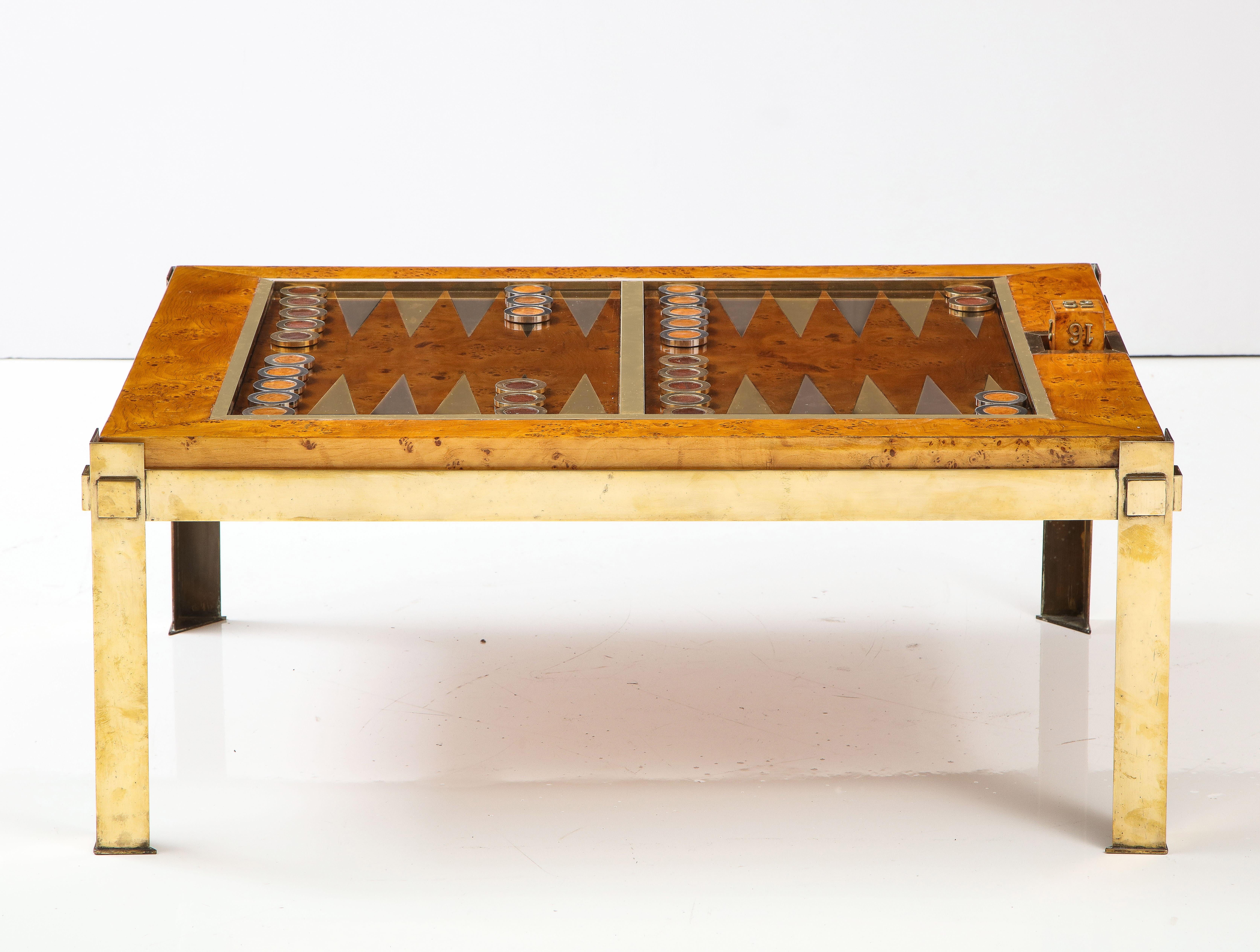 An exquisitely designed backgammon table by Tommaso Barbi, Italy, 1960`s. The burled wood frame and board sit in a lacquered brass frame with angled brass legs. The table includes a full set of backgammon pieces, (chrome and wood and brass and wood)