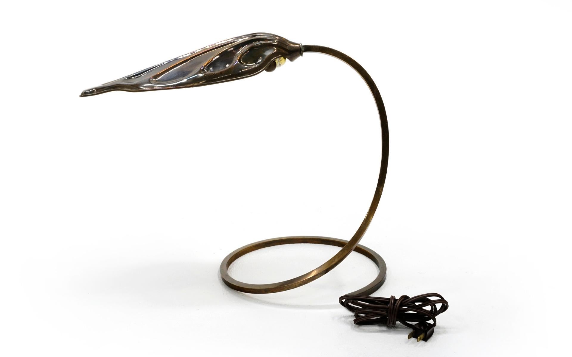 Brass table lamp designed by Tommaso Barbi, circa 1970. Rhubard leaf design with spiraling stem to a circular base. Beautifully patinated brass. This could be polished to a shine if one so desires.