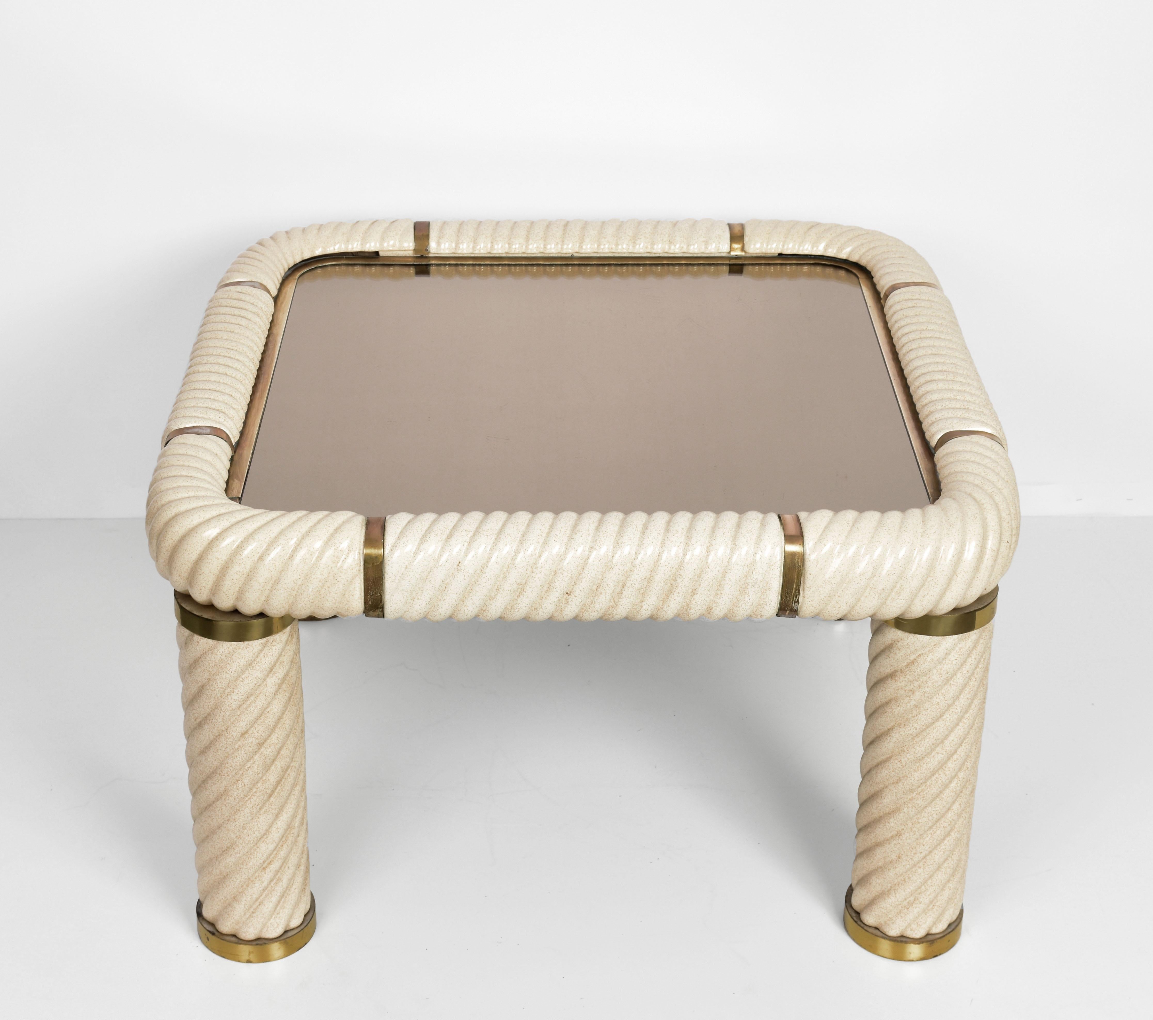 Amazing midcentury Hollywood Regency style ceramic brass and mirrored glass squared cocktail table. This wonderful item was designed in Italy during the 1970s and designed by Tommaso Barbi.

This remarkable piece features spiral-form ceramic