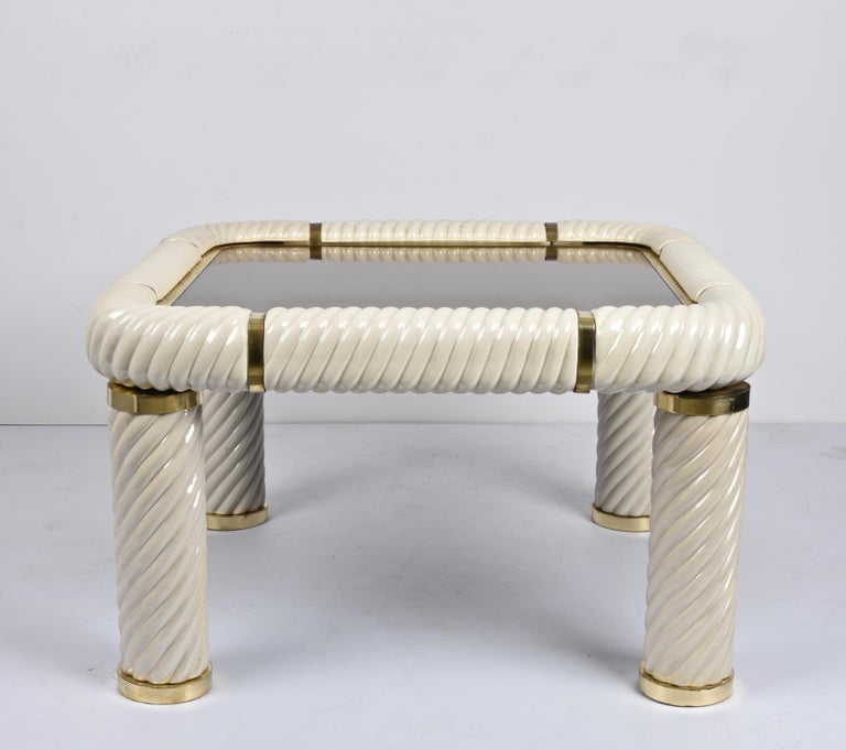 Amazing midcentury Hollywood Regency style ceramic brass and mirrored glass squared cocktail table. This wonderful item was designed in Italy during the 1970s and designed by Tommaso Barbi.

This remarkable piece features spiral-form ceramic