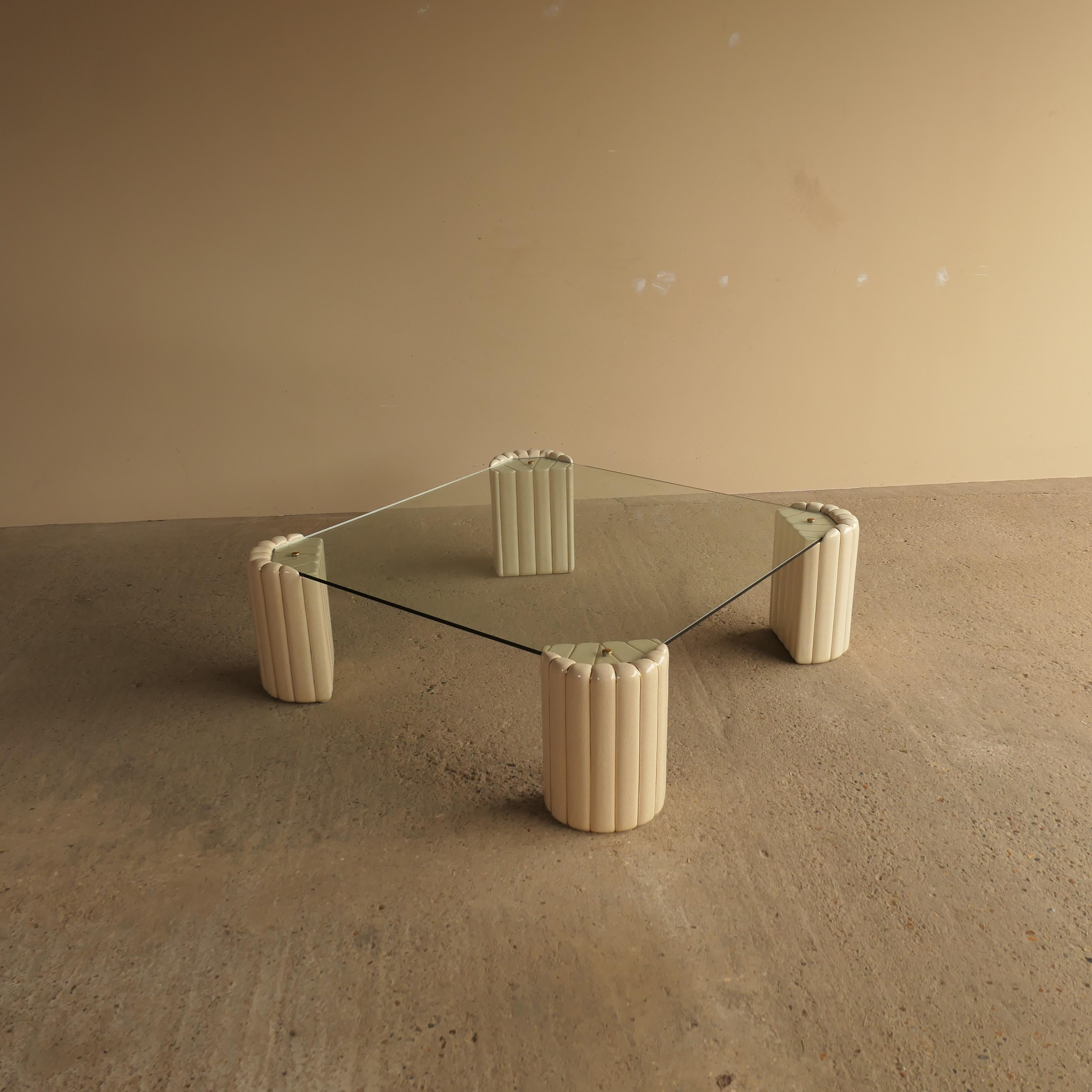 Striking mid-century modern coffee table designed by Tommaso Barbi, Italy, circa 1970. The table features sculptural ceramic legs with a thick glass top and brass fittings, showcasing Barbi’s signature blend of organic forms and luxurious