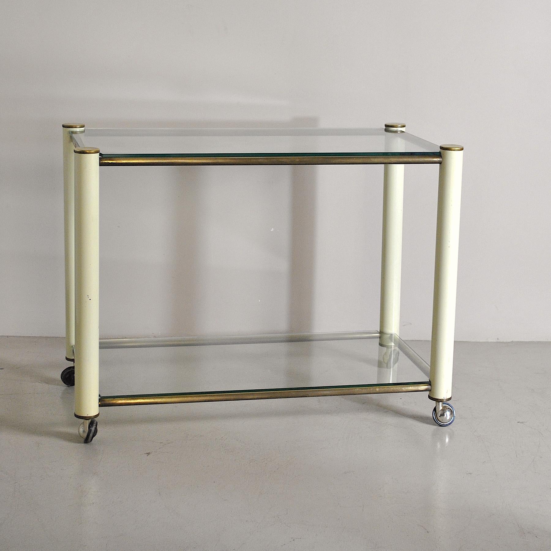 70s liquor bottle trolley with double glass shelf, the structure is made of brass and beige lacquered metal, Tommaso Barbi style.