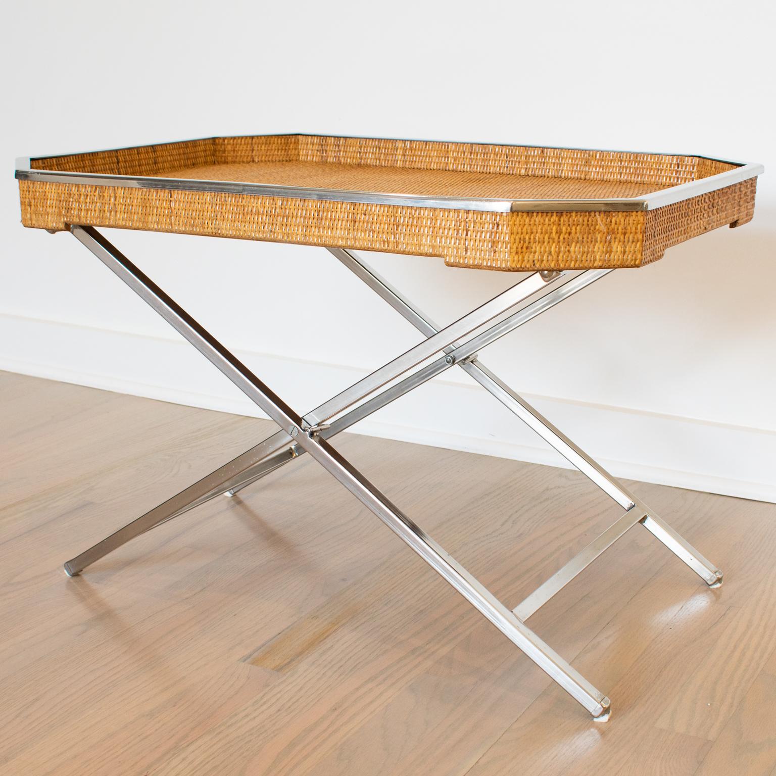 Tommaso Barbi designed this extraordinary large barware folding tray table in Italy, circa 1970. The rectangular butler shape boasts a chromed metal raised gallery and genuine rattan cane work or wicker. The table has a chrome metal folding X-stand.