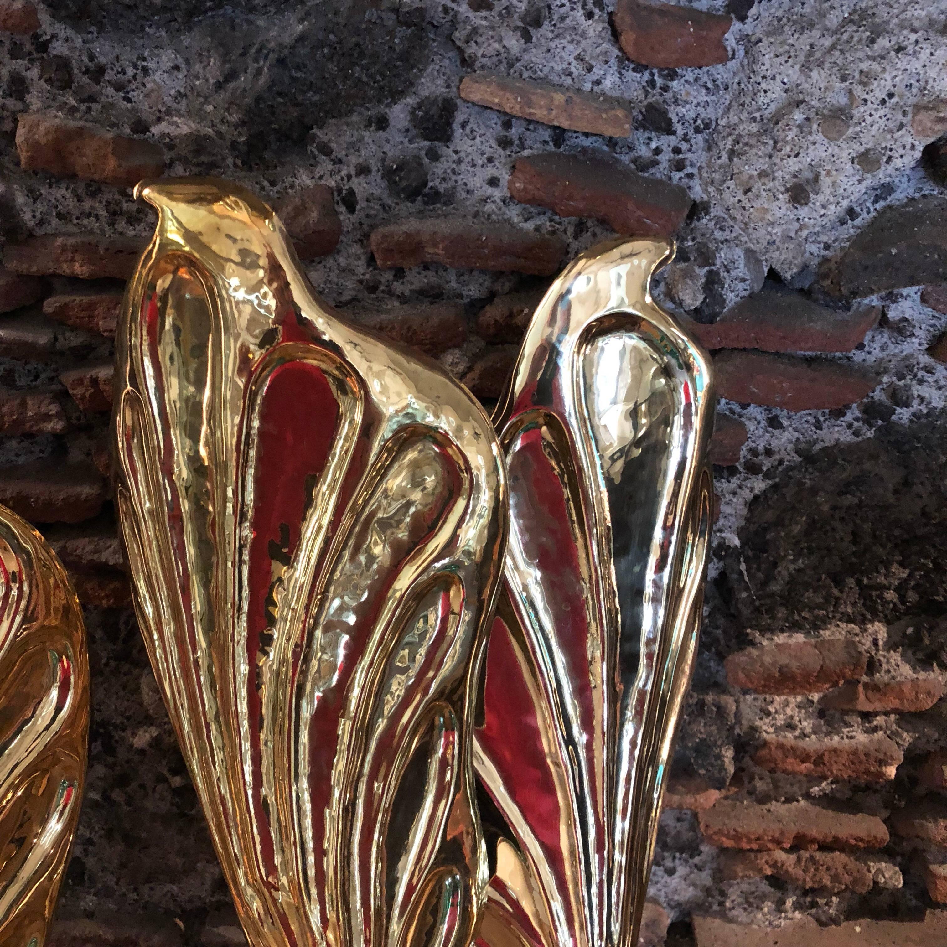 Pair of Mid-Century Modern double-arm leaf sconces designed by Tommaso Barbi for Carlo Giorgi, Italy, circa 1960-1965. The leaf sconces are hand-hammered. They need four x E14 European standard screw bulbs and work with both 110 and 240 Volt. The
