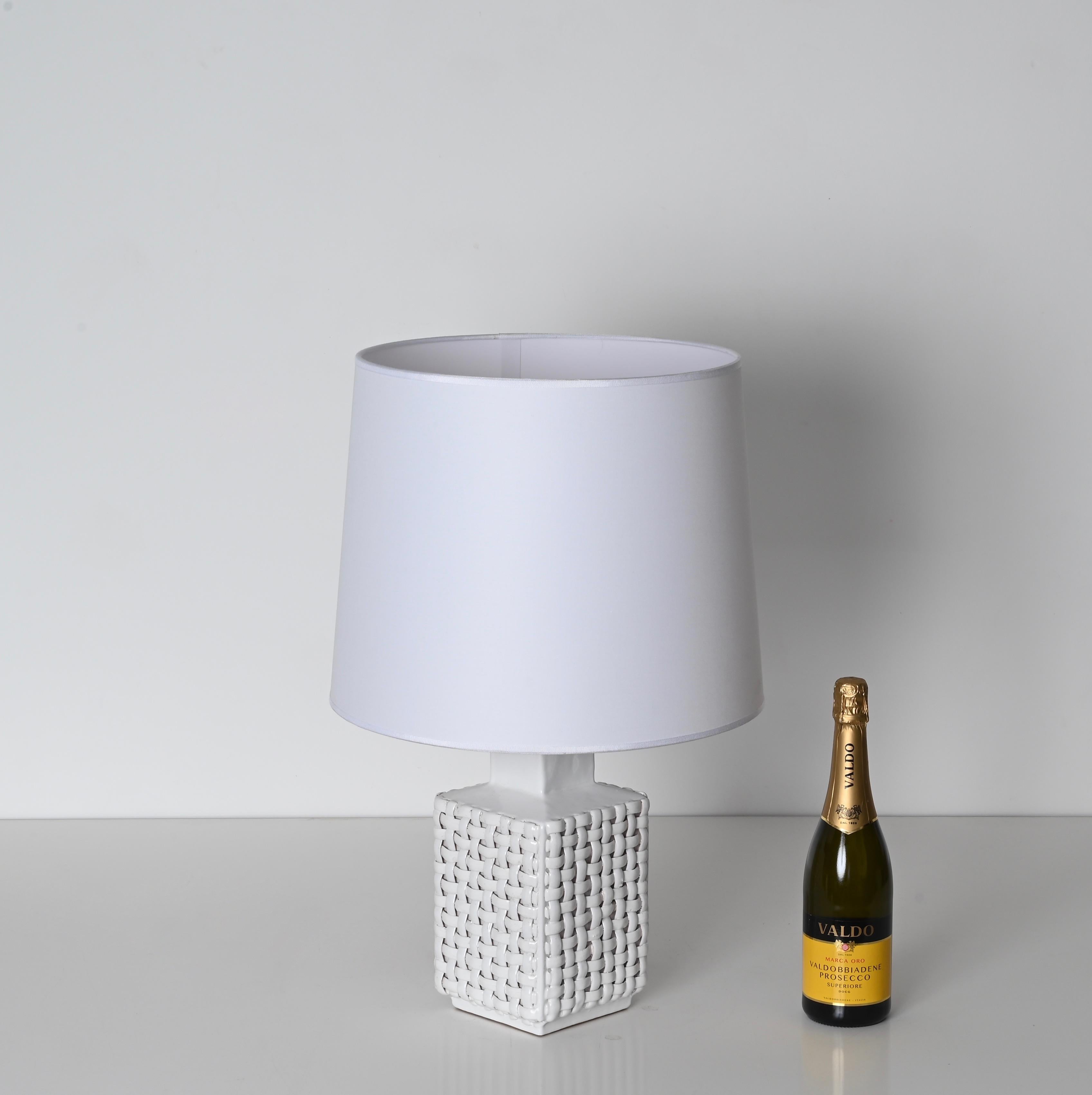 Splendida lampada di metà secolo in ceramica smaltata bianca, disegnata e firmata da Tommaso Barbi e prodotta in Italia nel 1970. 

Questa elegante lampada è realizzata in ceramica bianca smaltata, con il motivo del rattan intrecciato. Il tutto è