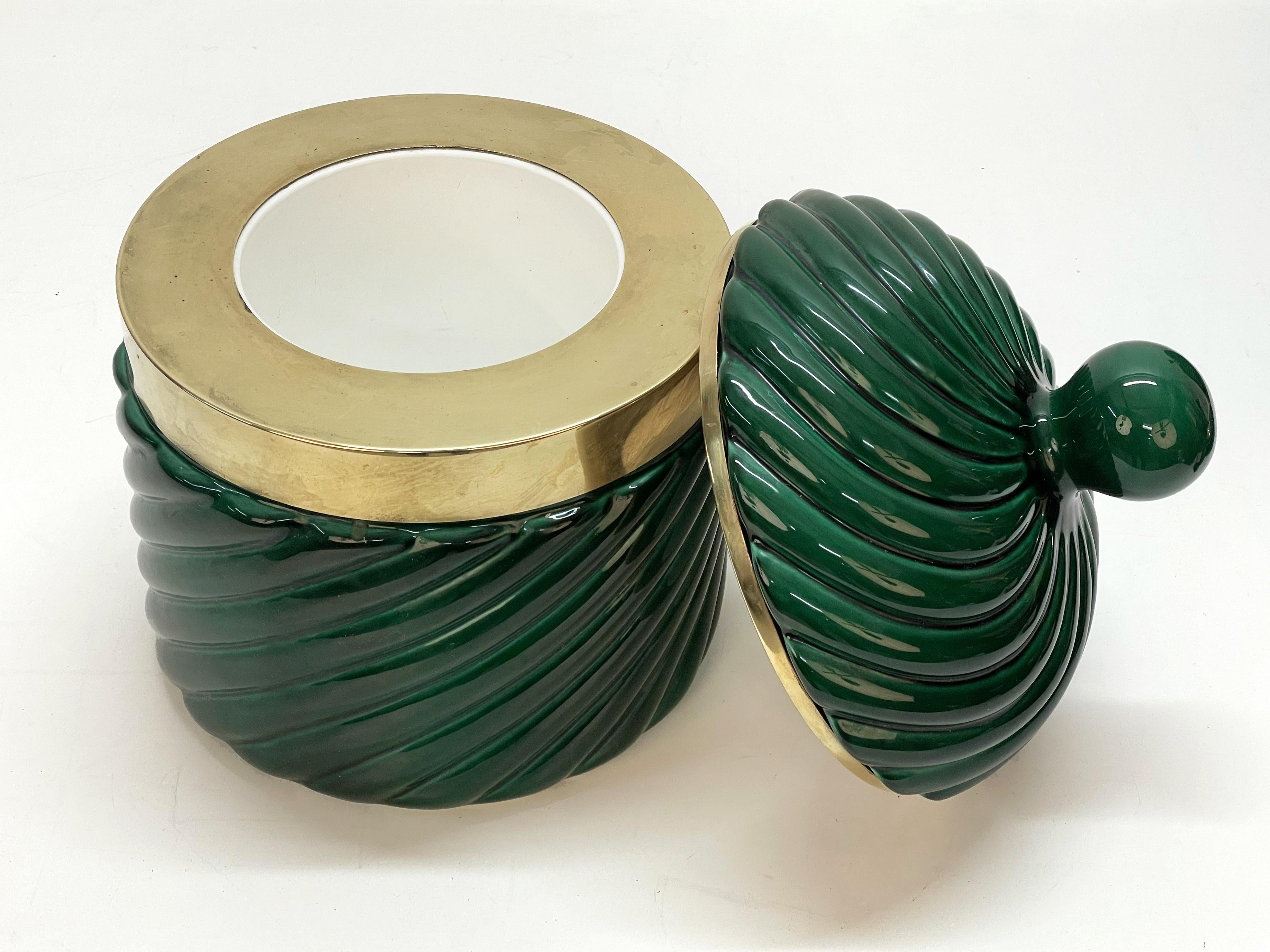 Amazing Mid-Century Modern green ceramic and brass ice bucket. This fantastic piece was designed by Tommaso Barbi and produced by B. Ceramiche during the late 1960s in Italy.

The brand of the manufacturer is below the case of the base, while on