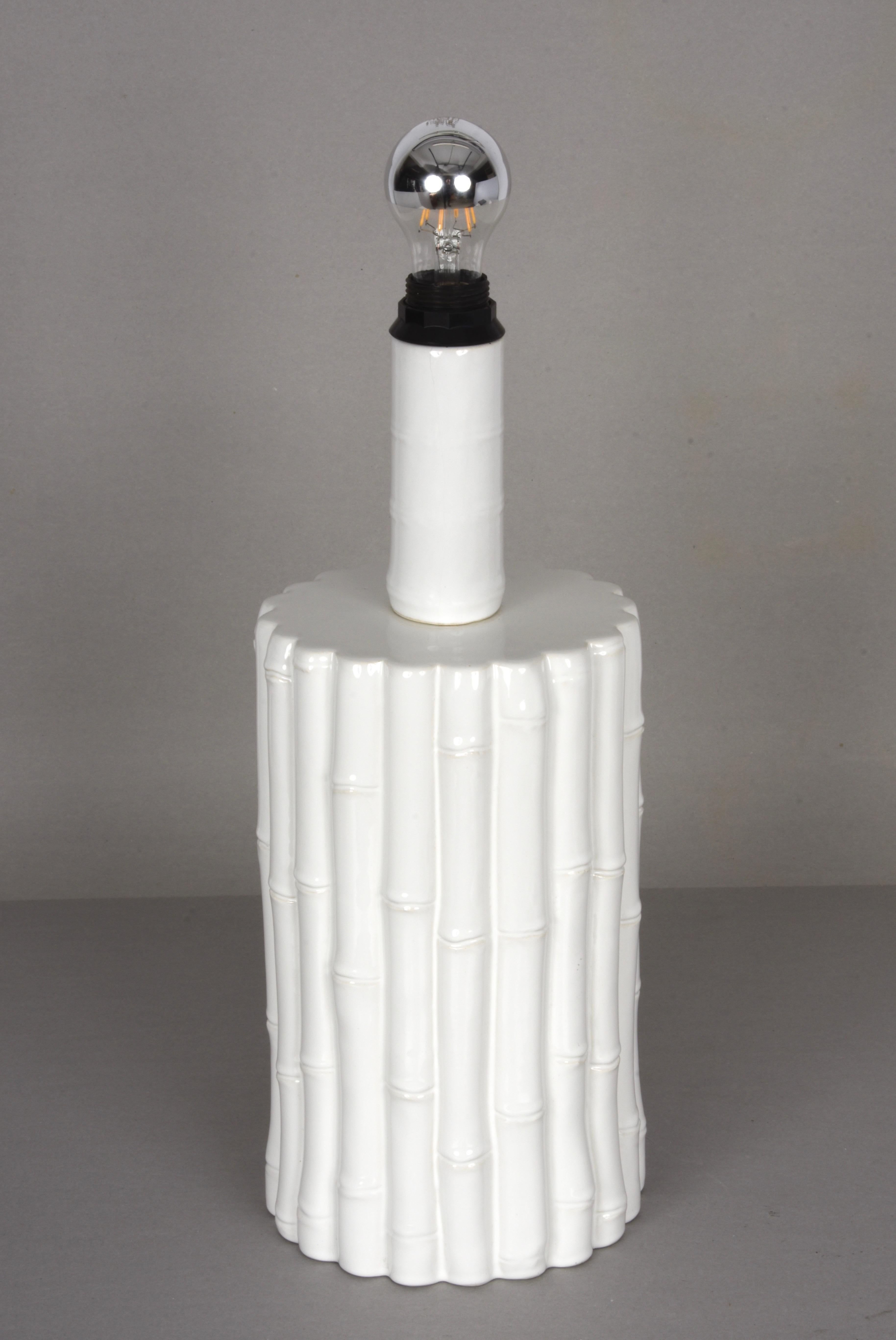 Iconic large midcentury white glazed ceramic lamp with white parchment lampshade. It was produced in Italy during the 1970s and is attributed to Tommaso Barbi.

The white ceramic body with its faux bamboo lines is a masterpiece of elegance, thanks