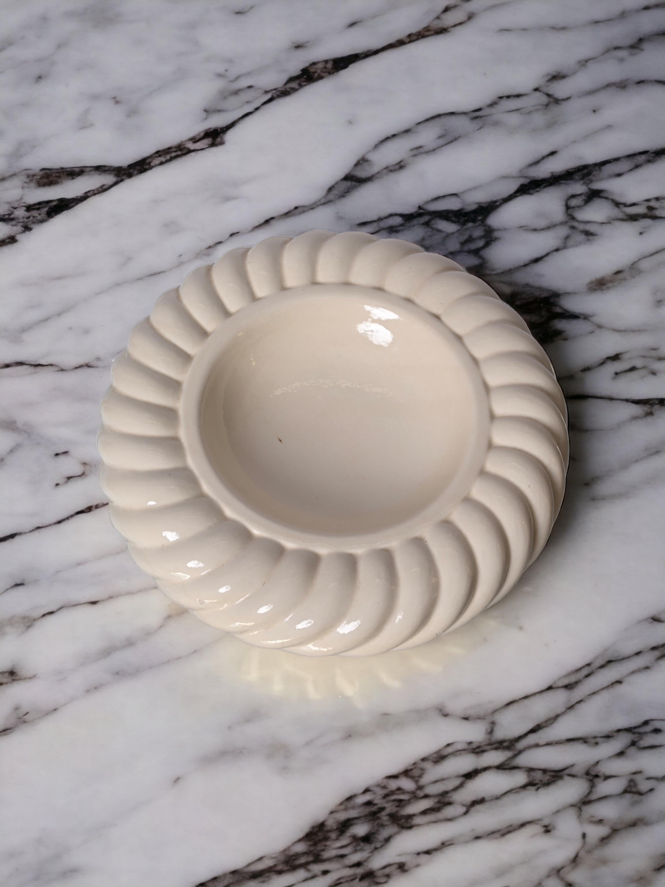 Incredible Mid-Century Modern white ceramic ashtray. This fantastic piece was designed by Tommaso Barbi and produced by B. Ceramiche in the late 1960s in Italy.

The manufacturer's brand stamp is at the bottom of the item while on the outside, the