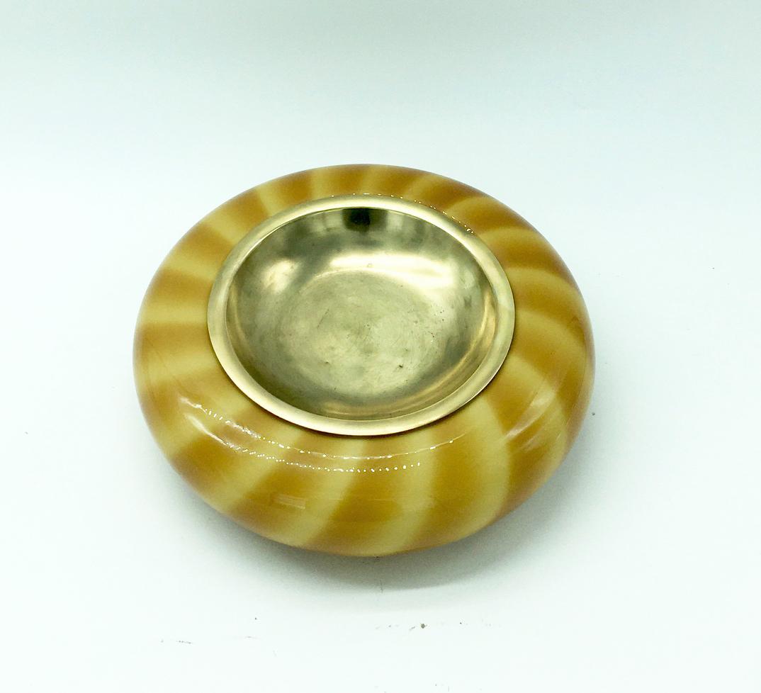 Ashtray / pocket emptier in amber Murano glass and brass interior made by the Italian designer Tommaso Barbi (signed on the bottom, original label still attached) in circa 1970.