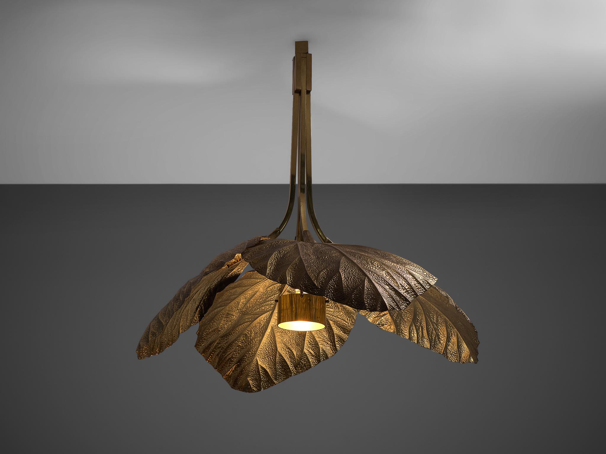 Tommaso Barbi, rhubarb leaf brass chandelier, Italy, 1970s.

This large brass chandelier is designed by Tommaso Barbi and produced in Italy in the 1970s. This biomorphic, hand-hammered brass ceiling lamp resembles four rhubarb leaves. The