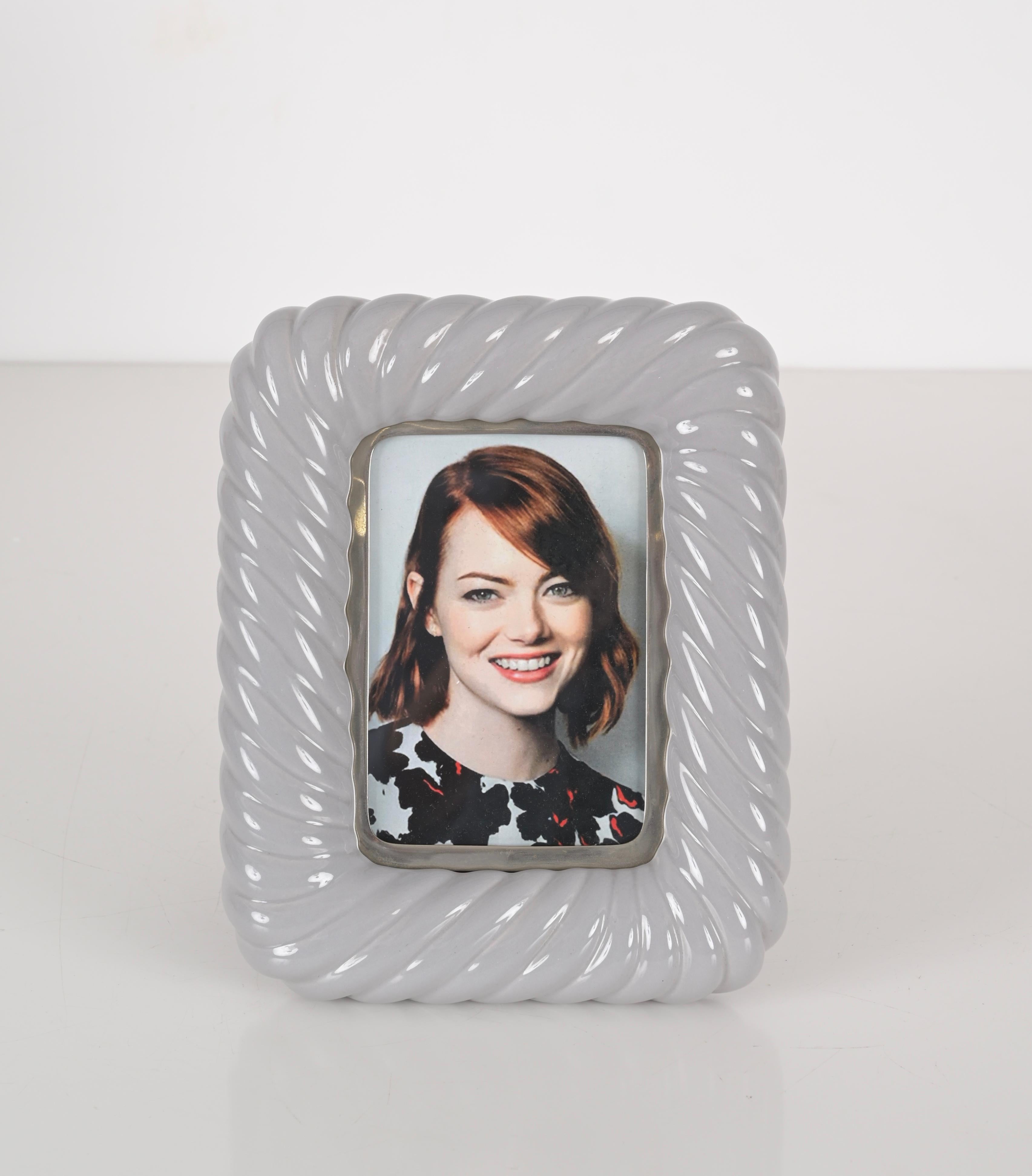 Gorgeous Mid-Century Tommaso Barbi picture frame in a rare grey ceramic and chrome version. This iconic object was designed in Italy during the 1970s by Tommaso Barbi, and is signed on the back.

This piece is unique for the fine craftsmanship on