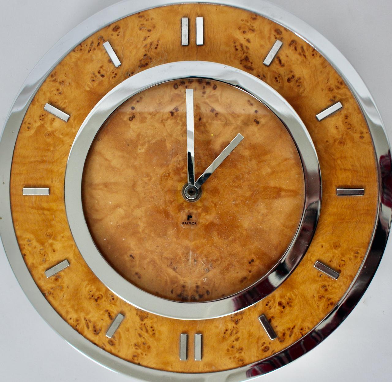 Tomasso Barbi attributed Circular Burl and Chrome Wall Clock by Raymor.  Featuring a round Chrome rimmed Burled Elm front with reflective Chrome surround. With German clock mechanism by Kienzle. Battery operated with single C Cell. In working order.