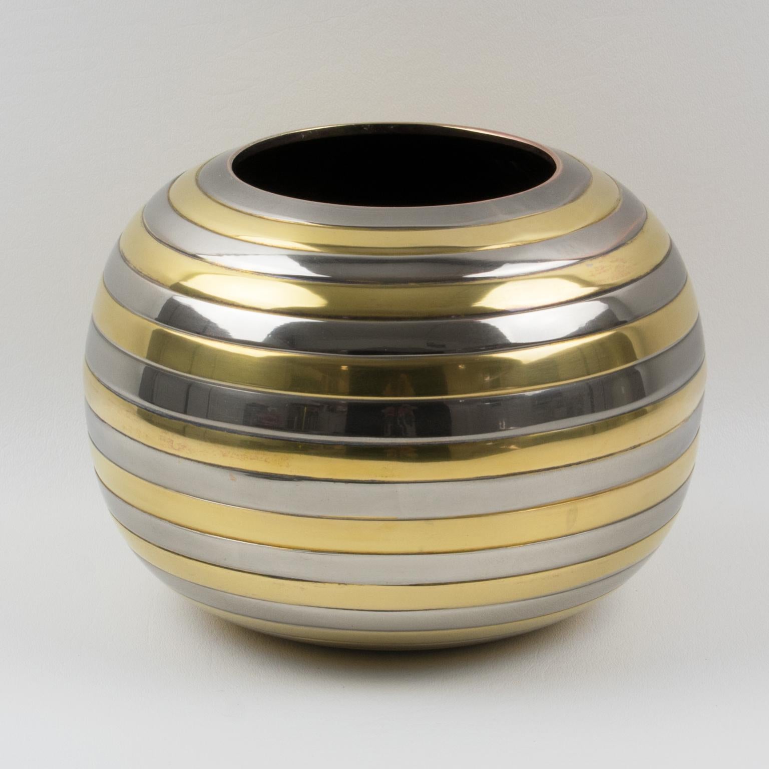 Interesting 1970s modernist vase, reminiscent of Tommaso Barbi's work. Space Age rounded shape with stripes in chrome and brass metal. No visible maker's mark.
Measurements: 5.94 in. high (15 cm) x 8.07 in. diameter (20 cm).