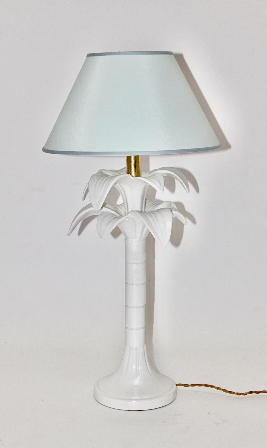 Palm Tree vintage table lamp by Tommaso Barbi from white glazed ceramic, brass and bakelite in the color tones white and gold 1970s Italy.
An elegant table lamp with Hollywood Regency style vibe and feel in wonderful white and pastel blue color by